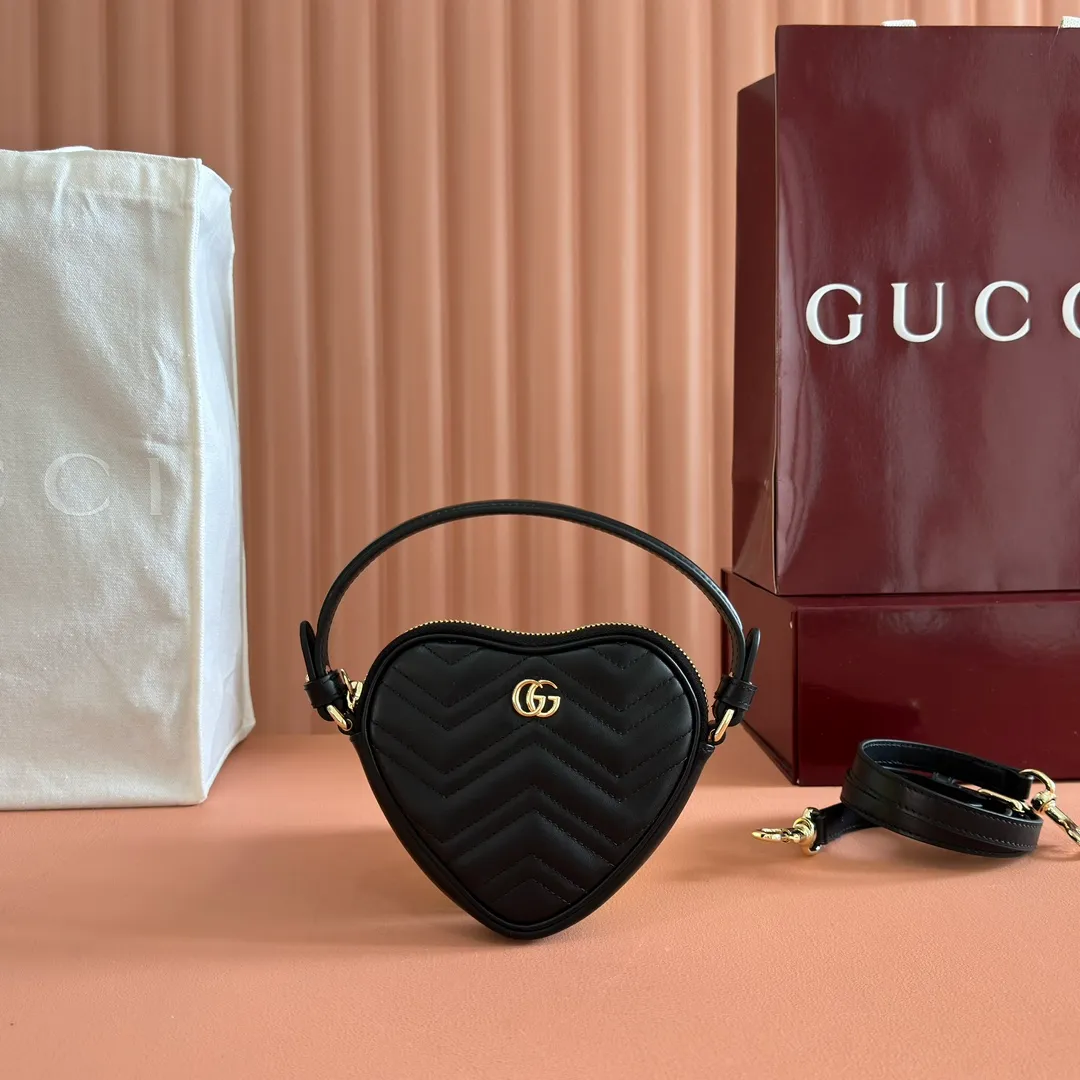 p940. 💋💋💋"With full set of original counter packaging" [New product] This GG Marmont series mini handbag has a playful and cute heart-shaped silhouette and is crafted from soft Gucci Ancola red V-shaped Matelassé cow leather. The bag has a simple and compact shape and is equipped with the iconic Double G accessories in light gold tones. Gucci Rosso Ancora red quilted V-shaped calfskin leather Light gold tone hardware Red taffeta lining Double G Interior: One card compartment Carry handle (8 cm height) Detachable and adjustable shoulder strap (48 cm height) Zip closure Weight: approx. 0.162 kg Ident number: 837753. Dimensions: 13.5cm (width) x 11.5cm (height) x 2.5cm (depth) Color: Black full leather. Made in Italy