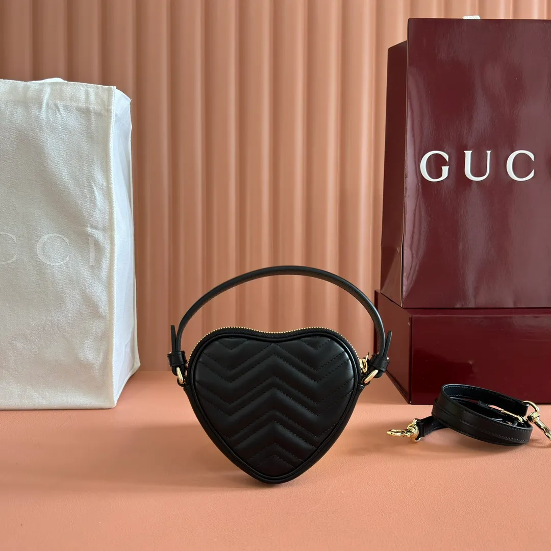 p940. 💋💋💋"With full set of original counter packaging" [New product] This GG Marmont series mini handbag has a playful and cute heart-shaped silhouette and is crafted from soft Gucci Ancola red V-shaped Matelassé cow leather. The bag has a simple and compact shape and is equipped with the iconic Double G accessories in light gold tones. Gucci Rosso Ancora red quilted V-shaped calfskin leather Light gold tone hardware Red taffeta lining Double G Interior: One card compartment Carry handle (8 cm height) Detachable and adjustable shoulder strap (48 cm height) Zip closure Weight: approx. 0.162 kg Ident number: 837753. Dimensions: 13.5cm (width) x 11.5cm (height) x 2.5cm (depth) Color: Black full leather. Made in Italy