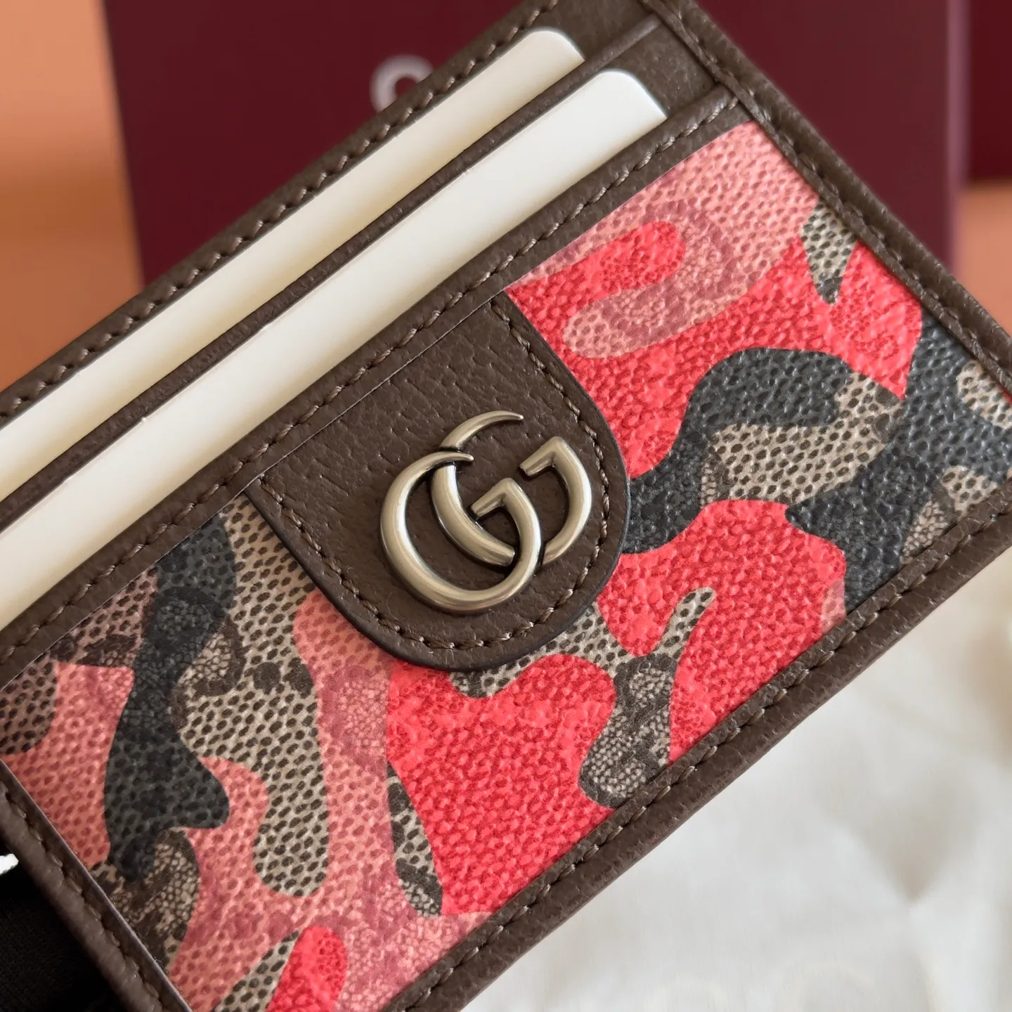 p300. 💋💋💋【With full set of original counter packaging】Vivid camouflage combined with unique color matching, a new interpretation of the classic GG pattern. This card holder is made of coated fabric with a marbled GG monogram pattern and features Double G details. Green and yellow camouflage marbled GG monogram coated fabric Brown leather trim Palladium tone hardware Brown taffeta lining Double G Web detail Interior: 1 open compartment Exterior: 4 card compartments Ident No.: 834795. Dimensions: 11cm (width) x 7cm (height) Weight: approx. 30g Red camouflage/PVC. Made in Italy