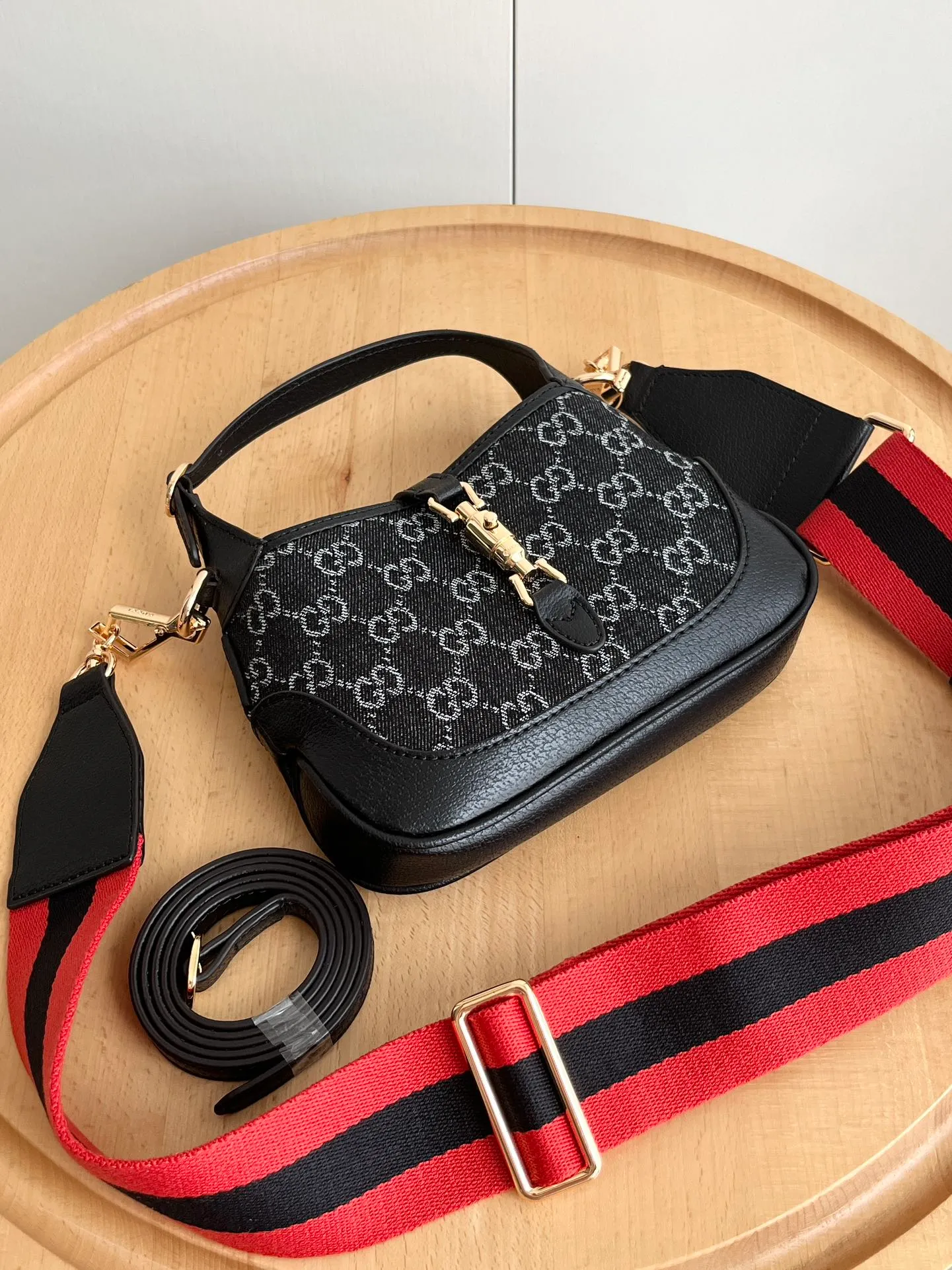 Actual shot #💰320 (double shoulder strap) Model: 685127 Small upgraded version Size: 19 x 13x 3cm.  Gucci UN3AG 1294 product details. Gucci's "Aria-Fashion Aria" series uses modern techniques to reinterpret classics. The Jackie 1961 series has launched a new rectangular tote bag with soft texture and flexible structure. The archive design is paired with logo details such as the all-over GG pattern and striped webbing, and exquisite accessories pay tribute to Gucci's heritage. This small bag is trimmed in black leather and features the collection's signature gold-toned push-lock hardware. Black and ivory GG denim jacquard. Black leather trim.