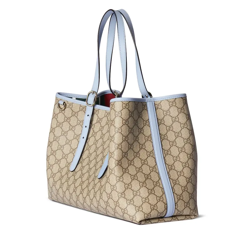 💕💕The GG Emblem series reinterprets the brand’s timeless elegance and exquisite craftsmanship. Inspired by the equestrian world, this tote bag features an adjustable top handle with numbered eyelets. New GG monogram coated fabric in beige and dark brown Light blue leather trim with contrast stitching Light gold tone hardware Red and green webbing cotton lining The bag pictured is sold separately and does not come with the bag charm. Also features D-ring for hanging removable items Adjustable handle with numbered eyelets (height: 21.5 cm - 31.5 cm) Interior: two compartments and one central zipped compartment Magnetic snap closure Ident.: 815213. Dimensions: 38cm (width) x 25cm (height) x 15cm (depth) Weight: about 0.85kg Color: brown pvc/original leather. Made in Italy