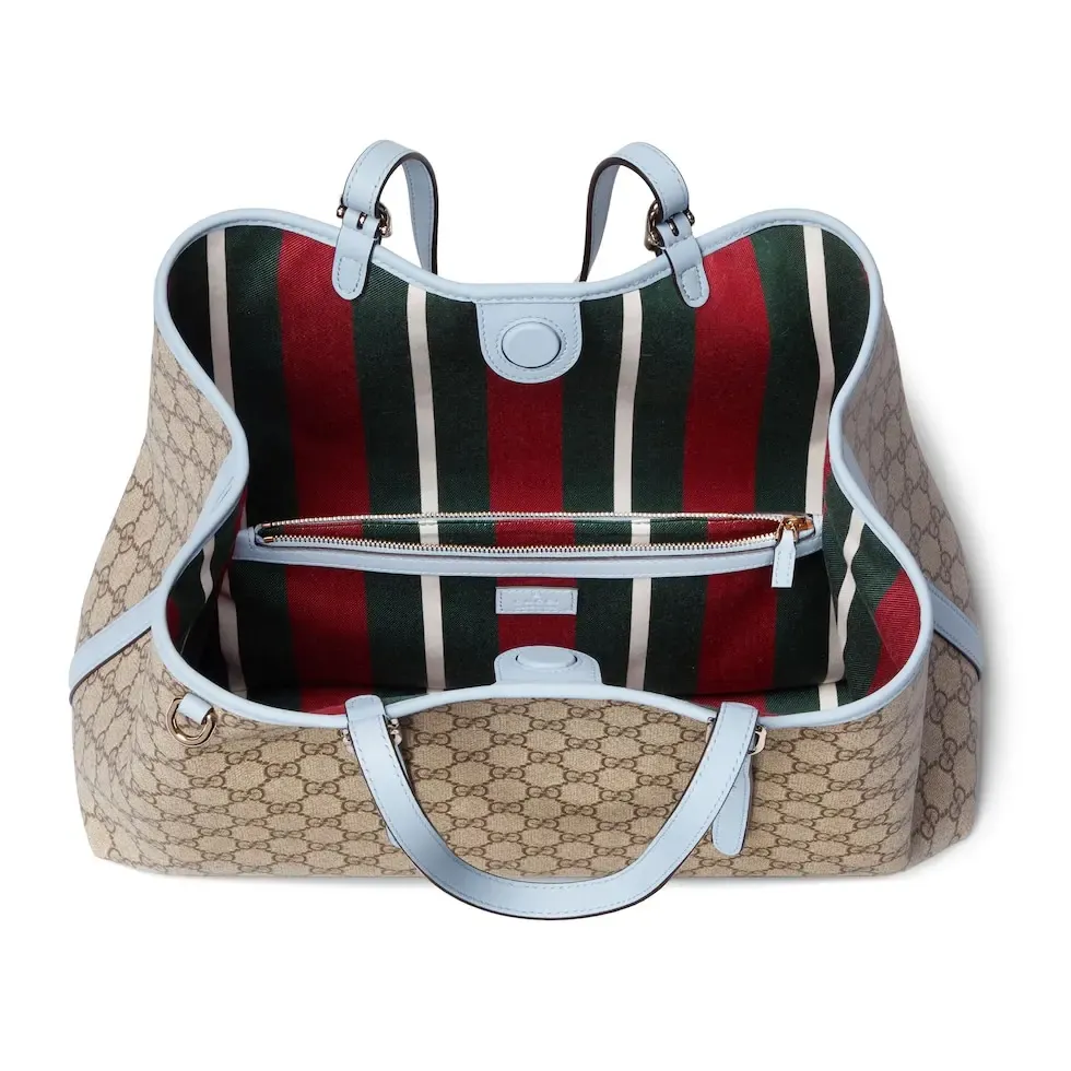 💕💕The GG Emblem series reinterprets the brand’s timeless elegance and exquisite craftsmanship. Inspired by the equestrian world, this tote bag features an adjustable top handle with numbered eyelets. New GG monogram coated fabric in beige and dark brown Light blue leather trim with contrast stitching Light gold tone hardware Red and green webbing cotton lining The bag pictured is sold separately and does not come with the bag charm. Also features D-ring for hanging removable items Adjustable handle with numbered eyelets (height: 21.5 cm - 31.5 cm) Interior: two compartments and one central zipped compartment Magnetic snap closure Ident.: 815213. Dimensions: 38cm (width) x 25cm (height) x 15cm (depth) Weight: about 0.85kg Color: brown pvc/original leather. Made in Italy