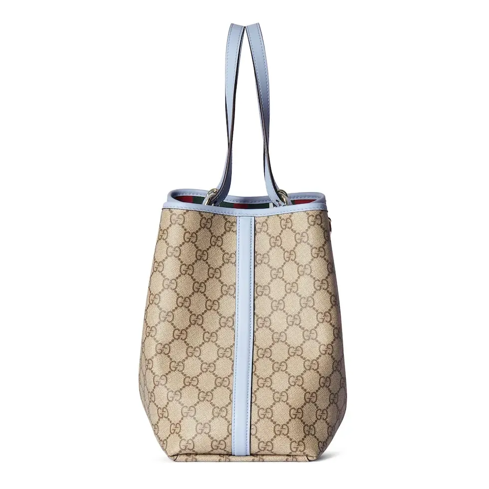 💕💕The GG Emblem series reinterprets the brand’s timeless elegance and exquisite craftsmanship. Inspired by the equestrian world, this tote bag features an adjustable top handle with numbered eyelets. New GG monogram coated fabric in beige and dark brown Light blue leather trim with contrast stitching Light gold tone hardware Red and green webbing cotton lining The bag pictured is sold separately and does not come with the bag charm. Also features D-ring for hanging removable items Adjustable handle with numbered eyelets (height: 21.5 cm - 31.5 cm) Interior: two compartments and one central zipped compartment Magnetic snap closure Ident.: 815213. Dimensions: 38cm (width) x 25cm (height) x 15cm (depth) Weight: about 0.85kg Color: brown pvc/original leather. Made in Italy