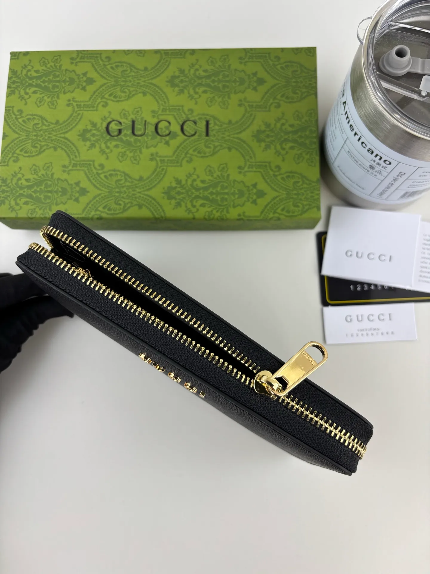 💰170 GUCCl Long zipper wallet with handwritten Gucci logo. Exploring self-expression with unlimited possibilities has become the spiritual connotation of brand design. Crafted from black leather, this long clip is embellished with a gold-toned handwritten Gucci logo-shaped hardware, adding a touch of the brand's signature charm to the entire design. Black leather, gold-tone hardware, taffeta lining, script Gucci logo detail. Interior: Six card compartments, two bill compartments, two separate internal compartments and a zippered coin pocket, this classic piece features a zipper closure Style number: 772642 Dimensions: 19cm x 10cm x 3.5cm Colour: Black