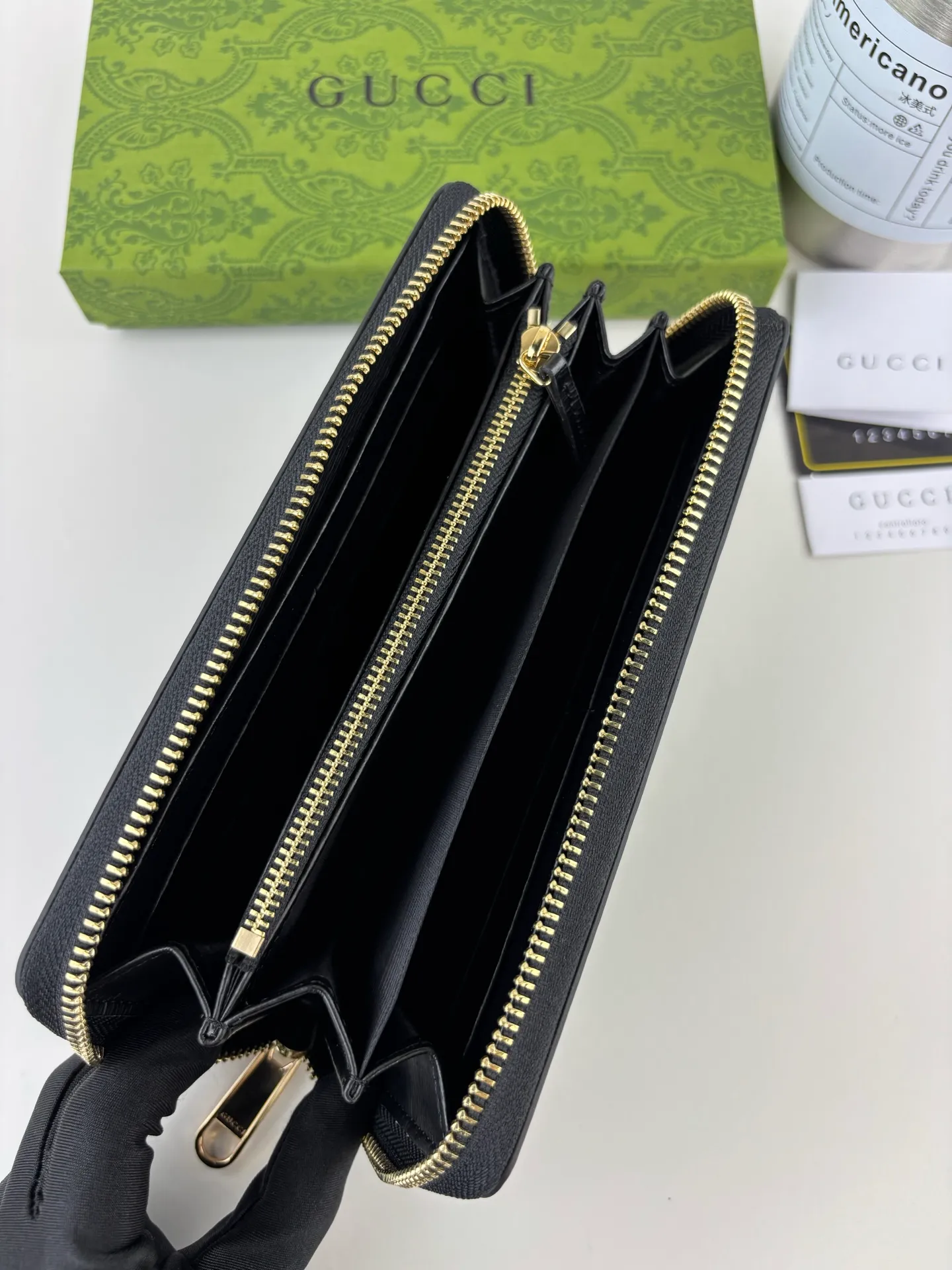 💰170 GUCCl Long zipper wallet with handwritten Gucci logo. Exploring self-expression with unlimited possibilities has become the spiritual connotation of brand design. Crafted from black leather, this long clip is embellished with a gold-toned handwritten Gucci logo-shaped hardware, adding a touch of the brand's signature charm to the entire design. Black leather, gold-tone hardware, taffeta lining, script Gucci logo detail. Interior: Six card compartments, two bill compartments, two separate internal compartments and a zippered coin pocket, this classic piece features a zipper closure Style number: 772642 Dimensions: 19cm x 10cm x 3.5cm Colour: Black