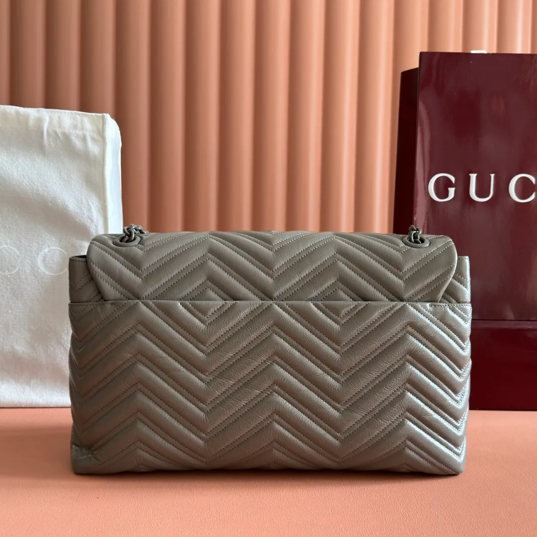 p1960. 💋💋💋【With full set of original counter packaging】2025 autumn and winter series, the brand's iconic GG Marmont series is ingeniously integrated with classic double G elements and faceted chain straps, creating a soft yet crisp silhouette design. This piece is crafted from soft, lightweight quilted V-shaped calfskin leather and features tonal enamel hardware and chain. Black soft lightweight quilted V-shaped calfskin leather. Tonal enamel hardware and chain. Black rayon lining. Double G. Interior: Zippered pocket. Exterior: Back open pocket. Magnetic closure. Ident.: 850659. Dimensions: 37.5cm (W) x 21cm (H) x 9cm (D) Color: Gray/Soft Leather. Made in Italy