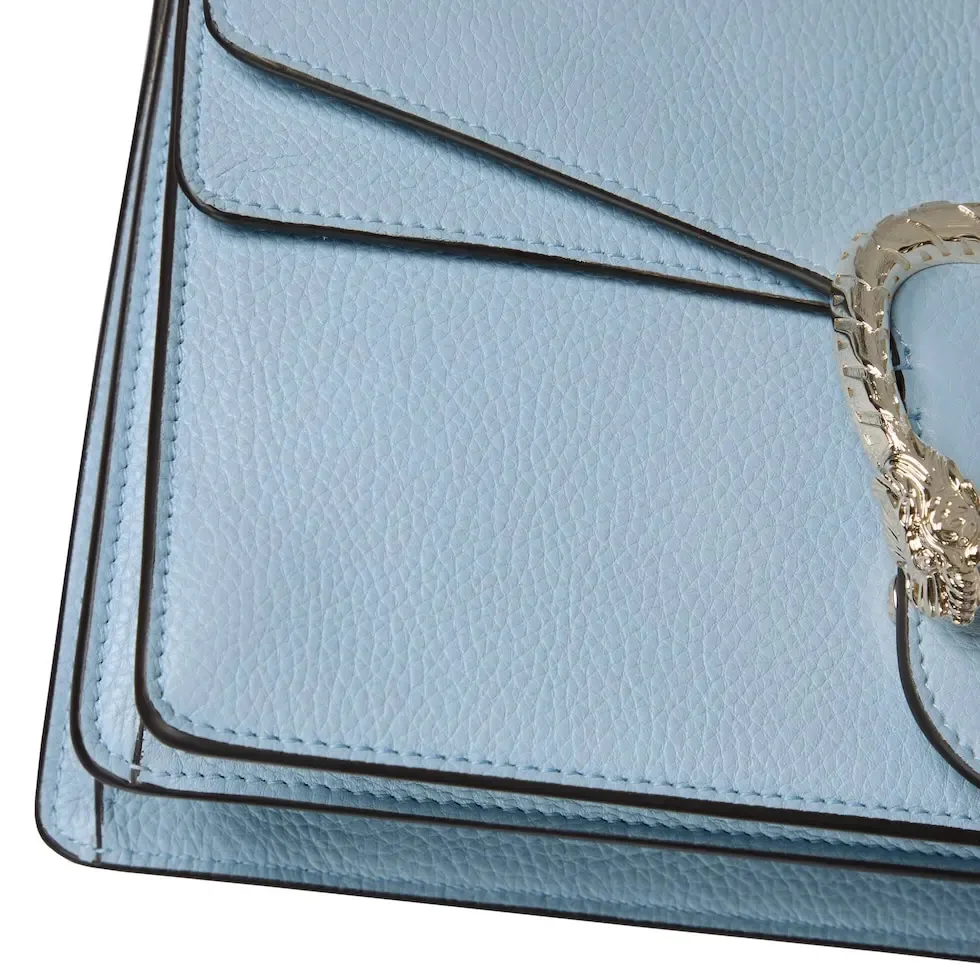 This piece is crafted from light blue leather and has a double tiger head lock with a flip design. The length can be adjusted freely by sliding the chain to create different styles. Light blue leather Light gold-tone hardware Light blue microfiber lining Pin buckle, side opening Double tiger head lock closure Internal zip compartment Flap pocket Double baffles Sliding chain shoulder strap can be adjusted to a shoulder strap with a height of 43 cm, or a top handle with a height of 24 cm. Weight: about 0.8 kg Model: 795005. Dimensions: 28cm (width) x 16cm (height) x 10.5cm (depth) Color: light blue full leather/original leather. Made in Italy