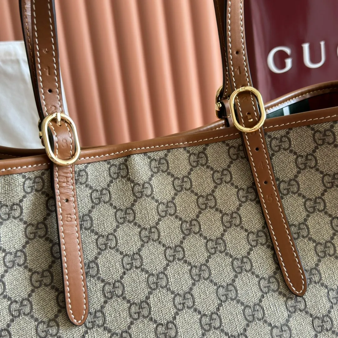 p980. 💋💋💋"With full set of original counter packaging" [New product] GG Emblem series reinterprets the brand's timeless elegance and exquisite craftsmanship. Inspired by the equestrian world, this tote bag features an adjustable top handle with numbered eyelets. New GG monogram coated fabric in beige and dark brown Orange leather trim with contrast stitching Light gold tone hardware Red and green webbing cotton lining The bag pictured is sold separately and does not come with the bag charm. Also features D-ring for hanging removable items Adjustable handle with numbered eyelets (height: 21.5 cm - 31.5 cm) Interior: two compartments and one central zipped compartment Magnetic snap closure Ident.: 815213. Dimensions: 38cm (width) x 25cm (height) x 15cm (depth) Weight: about 0.85kg Color: brown PVC/original leather. Made in Italy