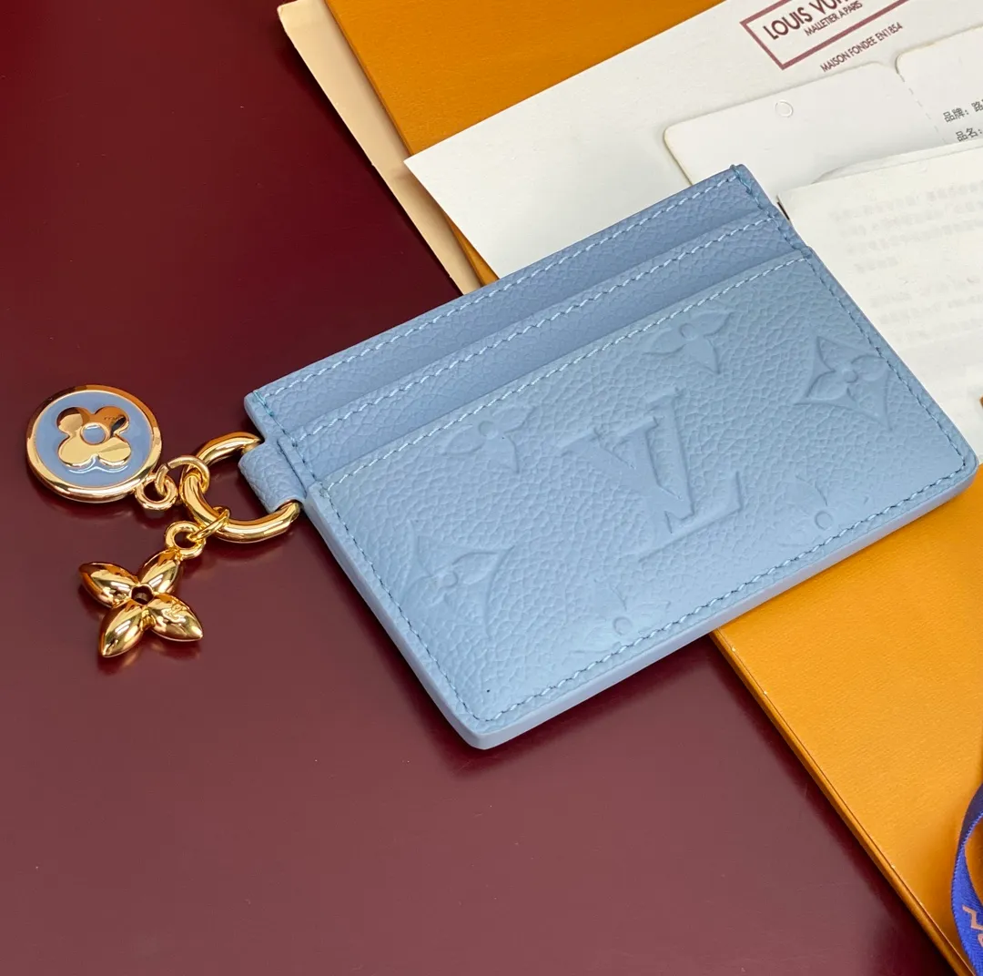 M13647 blue! LV CHARMS card holder! The LV Charms card holder from the LV Ski collection brings a pop of color to any accessory. Monogram Empreinte leather creates a unique structure. Monogram floral decorations are made of enamel technology and metal materials. There are card slots on both sides and a large compartment in the middle.  7.3 x 0.3 x 10.2 cm (height x width x length). 💰340