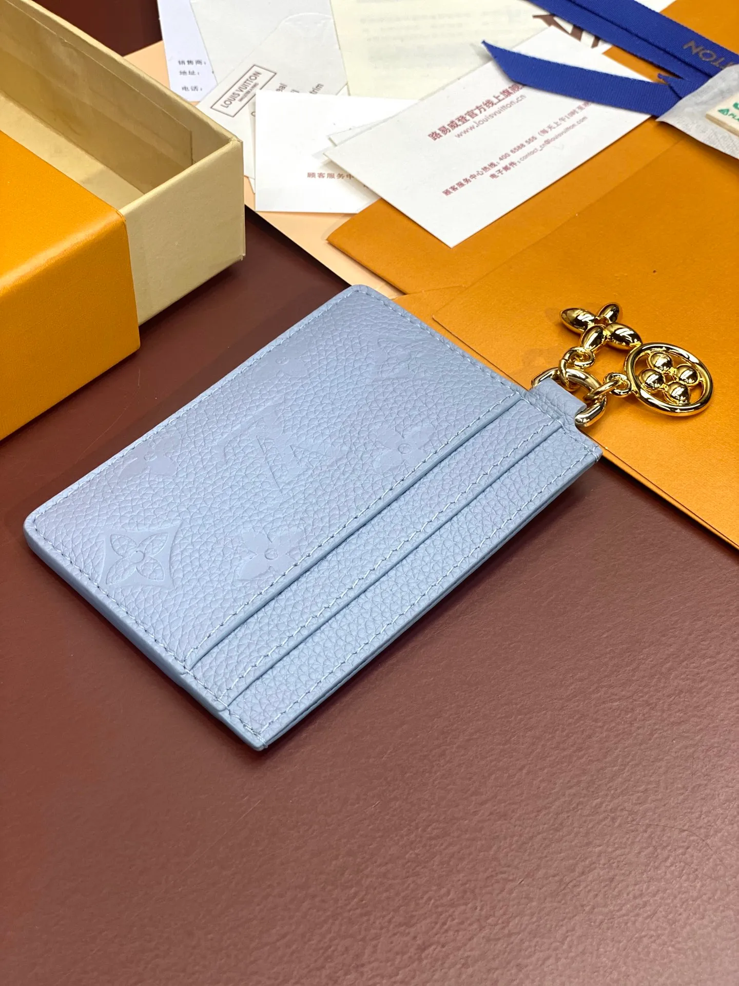 💰340 M82132 Haze Blue! [Pocket Card Holder Wallet] "Porto Cult LV Charm" made of Monogram Unplant leather. There are 2 card slots on each side and 1 large slot in the middle, for a total of 5 card slots, which is suitable for daily use. Decorated with 2 Monogram Flower pattern pendants, it adds an extremely feminine impression. Dimensions: 10.2 x 7.3 x 0.3 cm. .