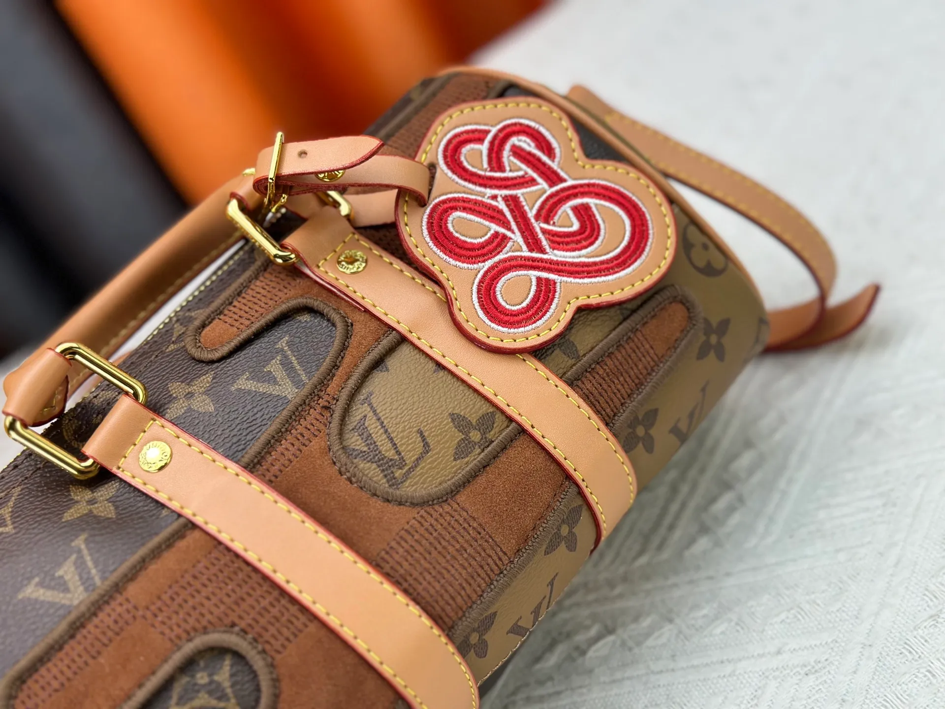 P300 M20900 M15428 Embroidered Parquet This Keepall Bandoulière25 handbag is inspired by the Japanese Boro patchwork craftsmanship. The classic Monogram canvas bag is embroidered with Monogram and Damier canvas to create a creative pattern that matches the terrain. 25 cm