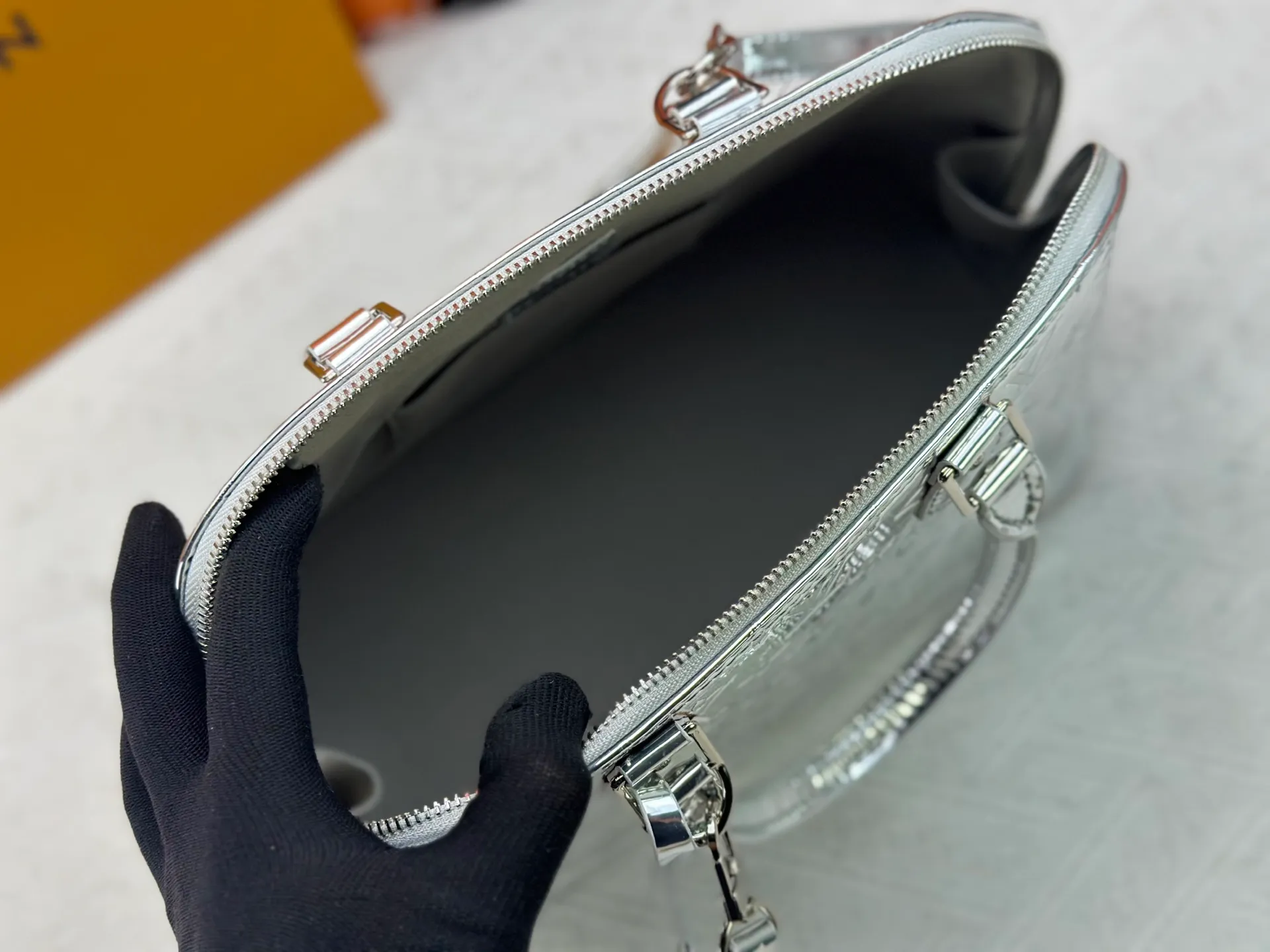 P320 M11835 M53151 The Alma large handbag in the LVSki series draws inspiration from the Louis Vuitton archive hard box. The large Monogram embossed coated canvas renders the new Monogram Miroir effect, highlighting the concept of retro futurism. Spacious interior patch pockets ensure organized storage. Size: 39x30x19cm