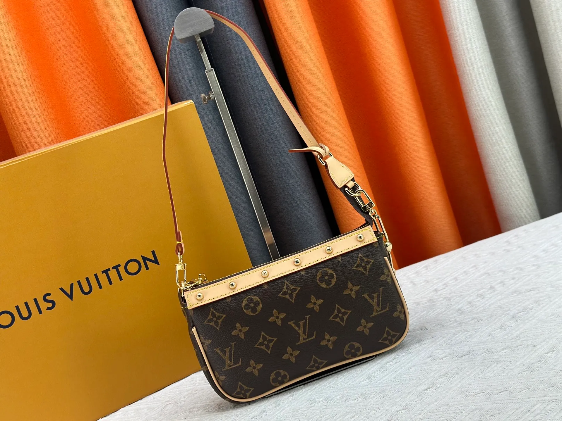P220 M13404 M13663 Black color White color This Pochette Accessoires handbag is made of coated canvas, with colorful Monogram patterns to interpret the smart style of the Louis Vuitton × Murakami cross-border collaboration series. Calf leather trim and dazzling hardware add to the sophisticated details, while the detachable shoulder strap and chain provide flexible carry. Size: 22x13x4cm