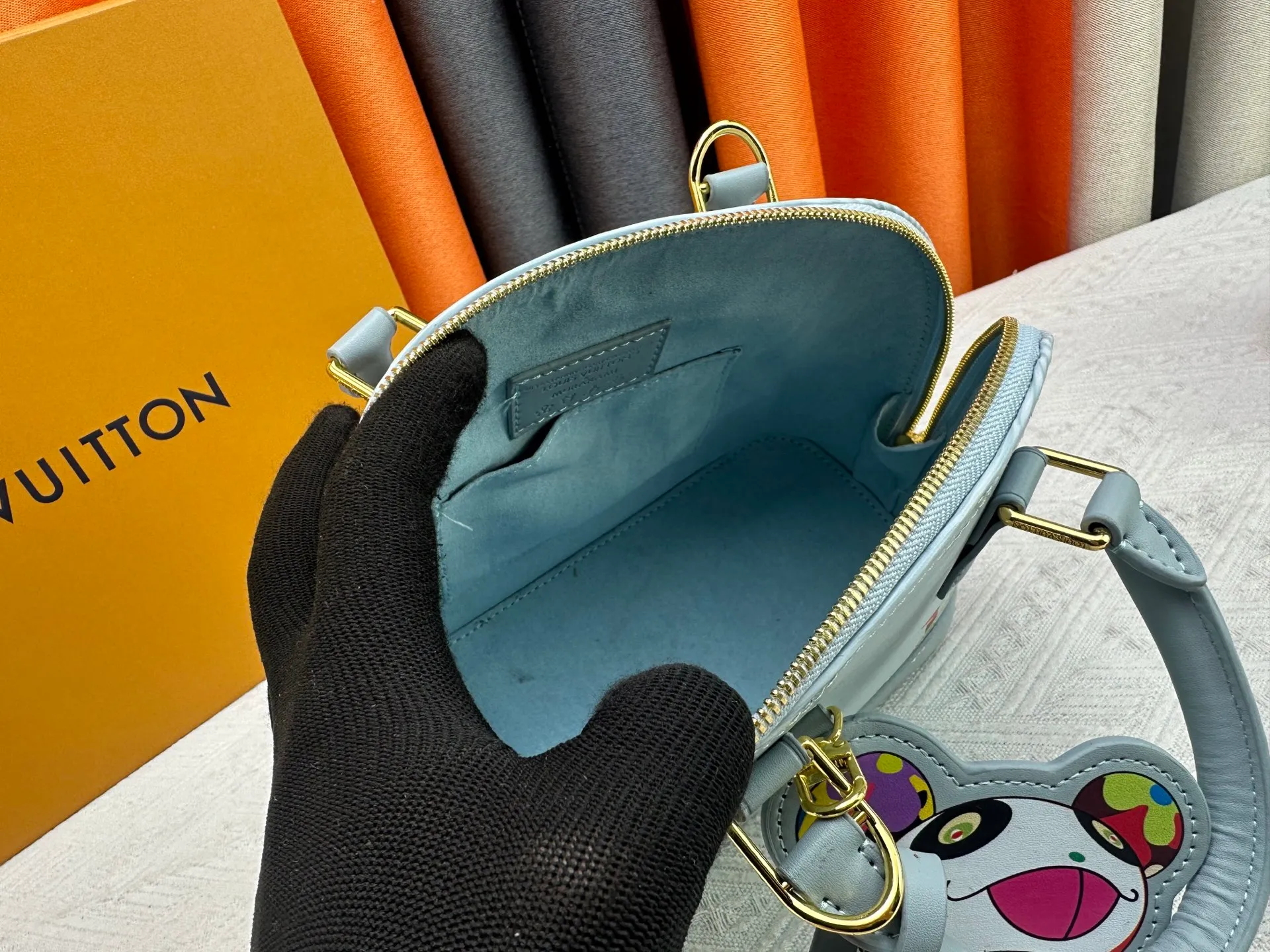 p300 Upgraded original M13670 M14197 M53152 This Alma BB handbag is made of Epi leather and appears in the Louis Vuitton x Murakami reissue series. The smart LV letters on the front reflect the Japanese artist's "ultra-flat" aesthetic, which contrasts with the removable distinctive panda decoration. Top handles, a removable shoulder strap and a dazzling padlock complete the Art Deco design. Dimensions: 23.5 x 17.5 x 11.5 cm (length x height x width)