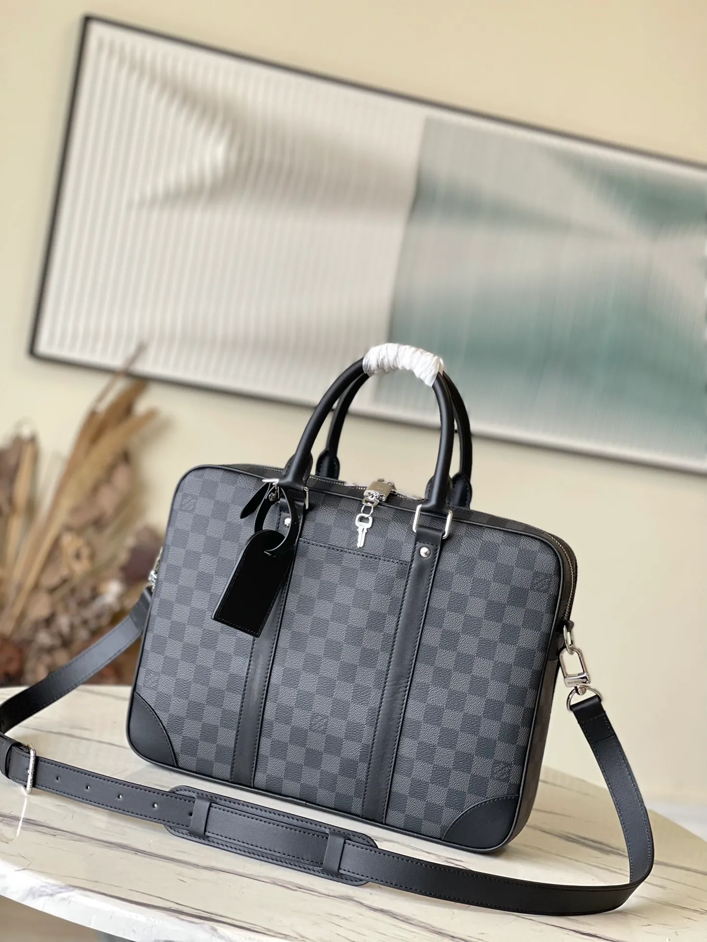 💰1000 Top Original N40445 This Voyage small briefcase is made of Damier Graphite coated canvas, with leather side straps, reinforced corners, top handles and nameplate. The outer pocket makes it easy to store a smartphone, the padded interior compartment holds a 13-inch laptop, and the removable and adjustable shoulder strap makes it comfortable to carry over the shoulder. Dimensions: 36.5 x 27.5 x 6 cm