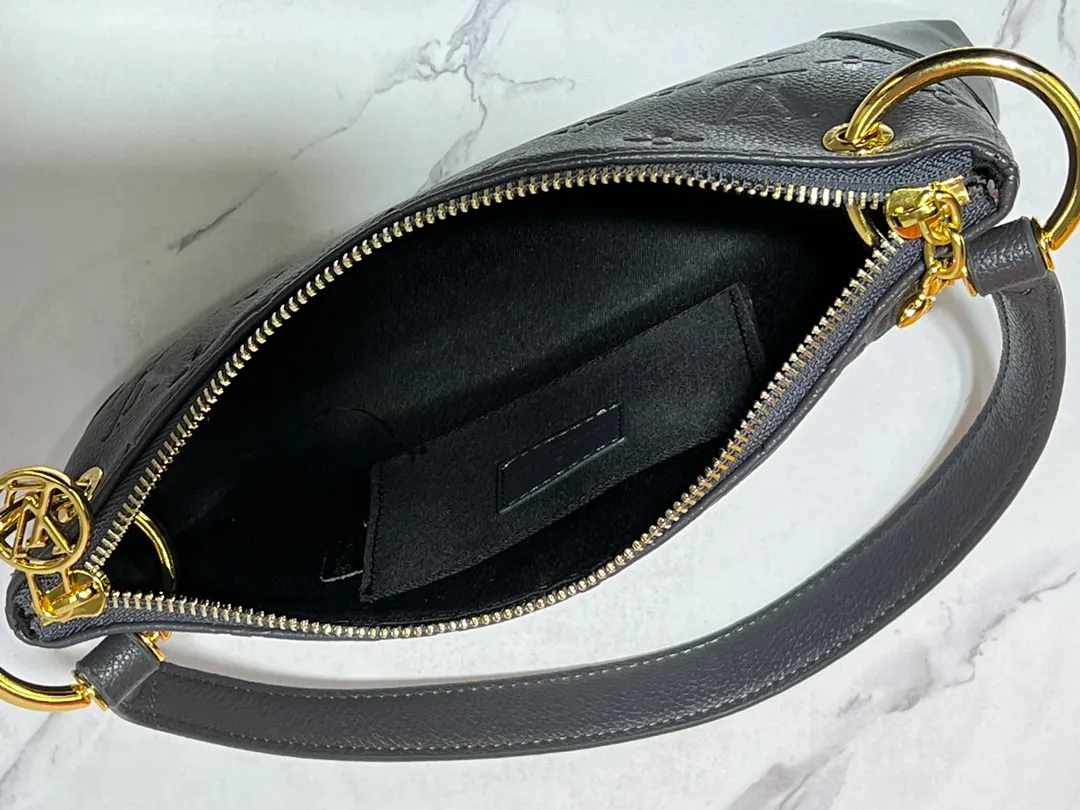 Batch 220💰Upgraded original M12174 This Pochette Sèvres belongs to the LV ski collection and is ready to shine in a "shiny" gun metal tone. It's crafted from signature Monogram Empreinte leather with pale gold hardware for an elegant contrast. The double zip closure features two pendants, one depicting an LV ring and the other displaying a crystal-embellished Monogram flower. Think of it as the perfect après-ski bag. Dimensions: 25 x 13 x 5 cm (length x height x width)