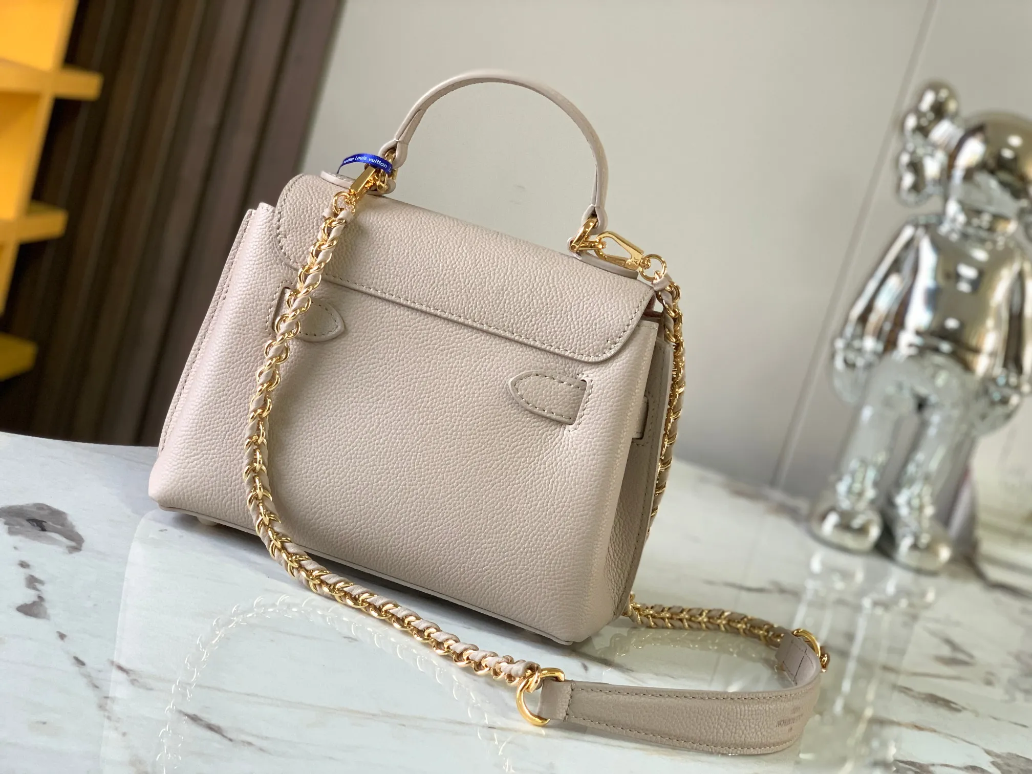 P1440【Original Leather💋M21052 Elephant Gray】This season, the small and exquisite Lockme Ever handbag is dyed in a fashionable new color of grained cow leather. Exquisite lines and the iconic LV padlock convey a trendy style. The elegant woven chain strap allows you to choose between cross-body or shoulder carry, and the top handle makes holding it more gentle. It is a perfect choice for carrying around day and night.   Detailed features 23 x 17x10 cm (length x height x width)