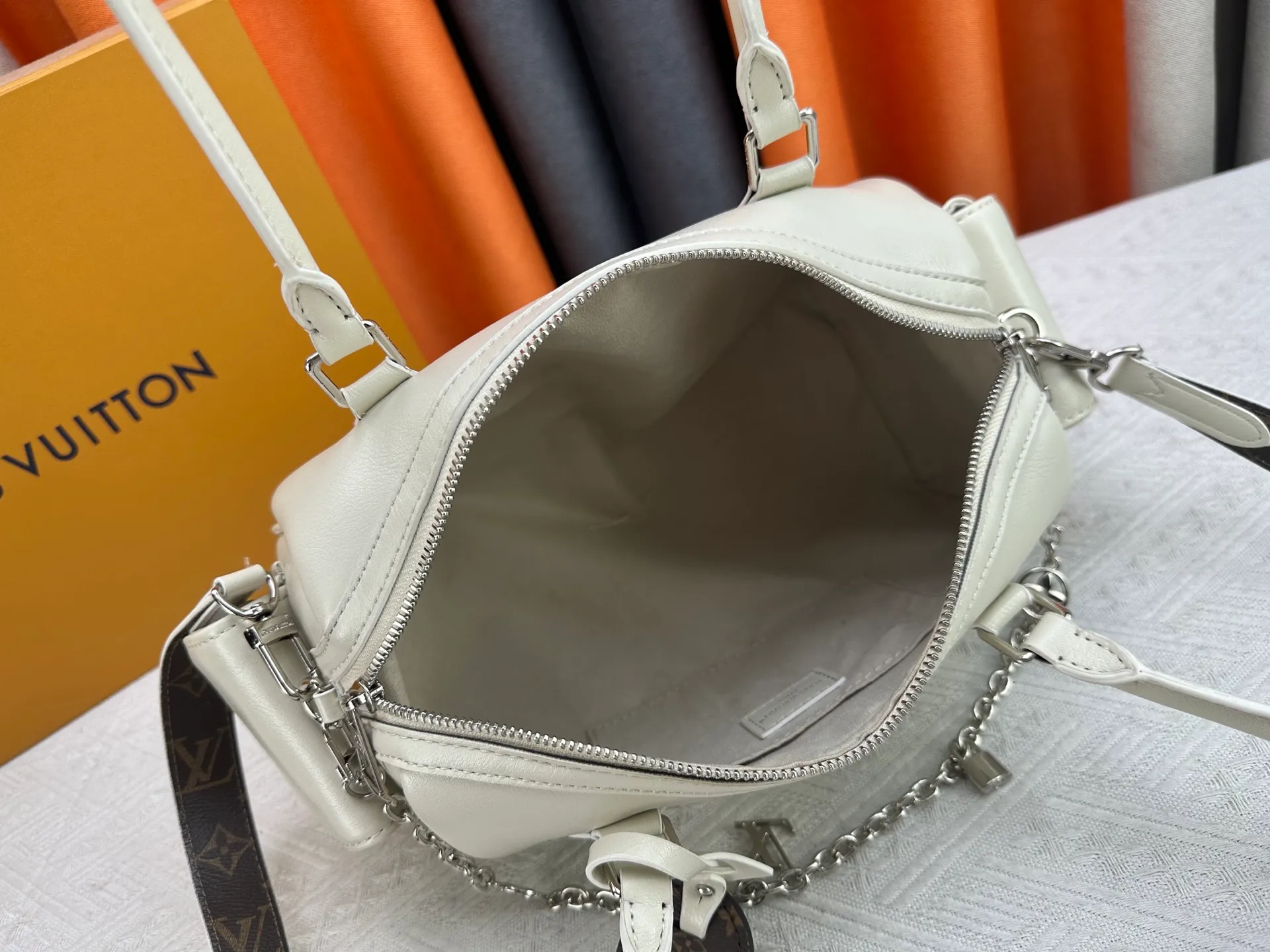 P300 Upgraded original M12934 M12965 This Speedy Cargo handbag is from the LV Vibe series, renovating the classic design of the 1930s with avant-garde touches. The glossy sheepskin body is embellished with a Monogram address plate, paying tribute to the brand's long trunk-making heritage. Plenty of space to easily store your daily needs, and the detachable leather shoulder strap allows for a variety of carrying methods. Dimensions: 28 x 17 x 12 cm (LxHxW)