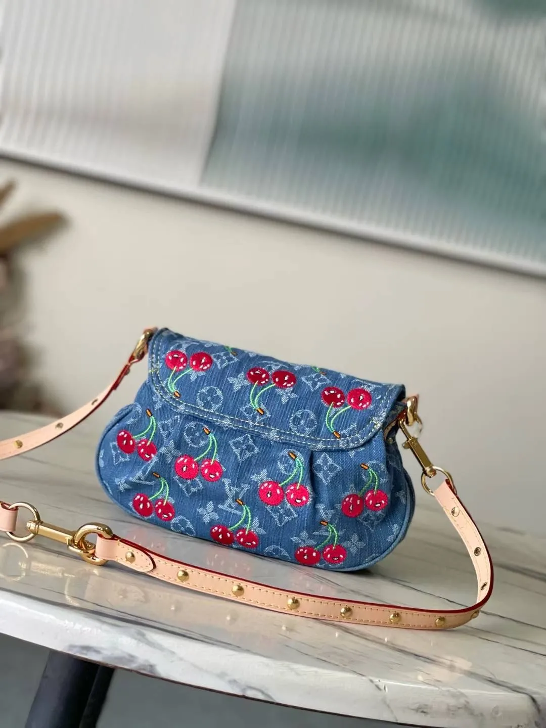 💰1180 Top original order M13680 This Sunset handbag is made of Monogram denim, with retro brushstrokes to create a rounded shape, and eye-catching buckles to brighten the design. The bright cherry embroidery highlights the smart style of the Louis Vuitton×Murakami replica series, and the studded leather shoulder strap completes the whole. Dimensions: 27 × 18 × 3 cm