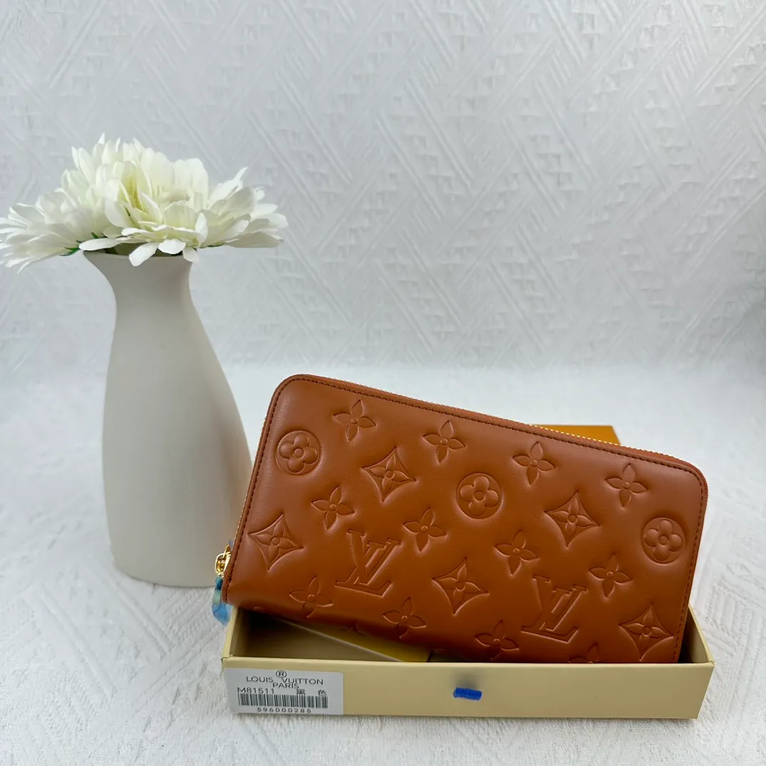 P130 M81511 Earthy Yellow Sewn with padded Monogram embossed lambskin, it complements the Coussin leather boutique series. Beautifully designed with a gold-tone zipper embossed with the LV Circle signature pull, the interior of the all-in-one wallet is packed with practical features, including three large compartments, a coin compartment and 12 business card slots. Dimensions: 19.5 x 10.5 x 2.5 cm