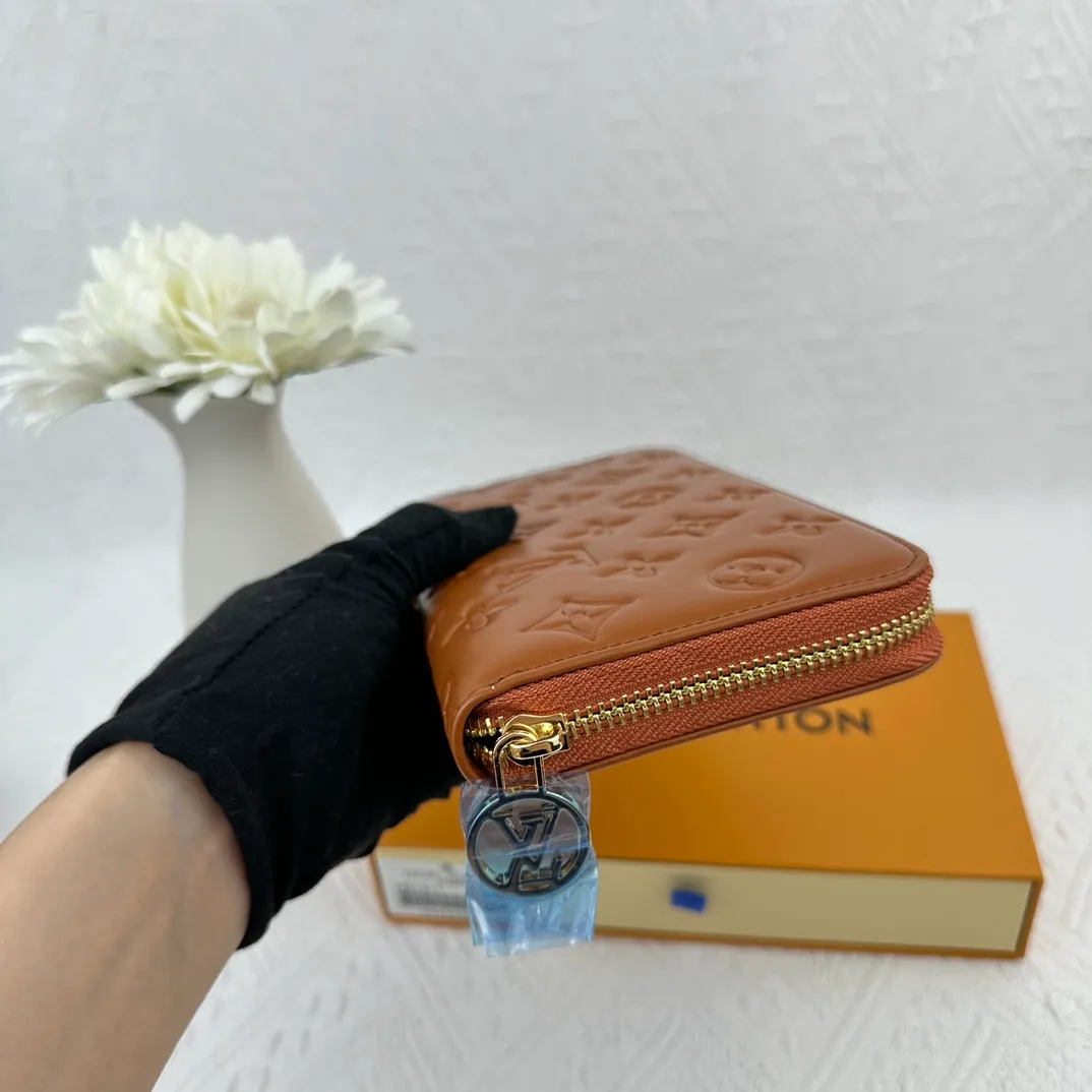 P130 M81511 Earthy Yellow Sewn with padded Monogram embossed lambskin, it complements the Coussin leather boutique series. Beautifully designed with a gold-tone zipper embossed with the LV Circle signature pull, the interior of the all-in-one wallet is packed with practical features, including three large compartments, a coin compartment and 12 business card slots. Dimensions: 19.5 x 10.5 x 2.5 cm