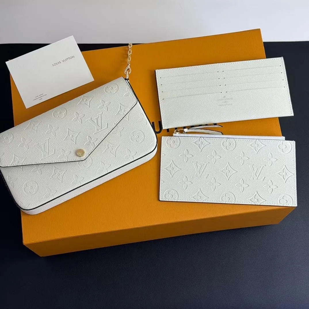 P150💰💖This Pochette Félicie three-in-one💖 chain bag is made of Monogram Empreinte leather, with subtle embossing to present Louis Vuitton’s classic Monogram pattern. The envelope-style construction offers ample interior space, and includes a removable zippered pocket and card compartment. Attach the chain to explore more modern carrying options. Model: M64065 white / 61276 Dimensions: 21 x 12 x 3 cm (length x height x width)