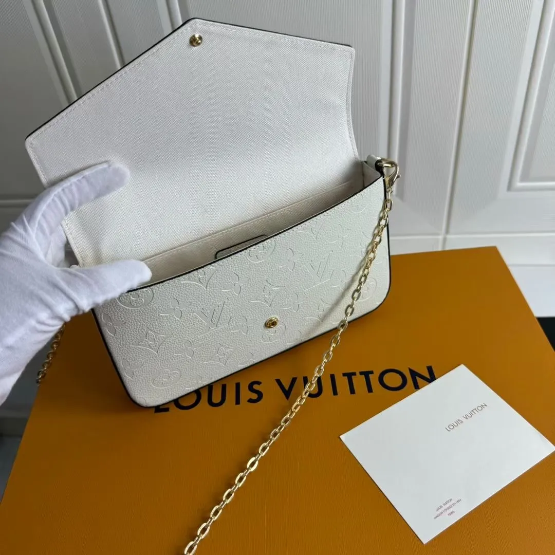 P150💰💖This Pochette Félicie three-in-one💖 chain bag is made of Monogram Empreinte leather, with subtle embossing to present Louis Vuitton’s classic Monogram pattern. The envelope-style construction offers ample interior space, and includes a removable zippered pocket and card compartment. Attach the chain to explore more modern carrying options. Model: M64065 white / 61276 Dimensions: 21 x 12 x 3 cm (length x height x width)