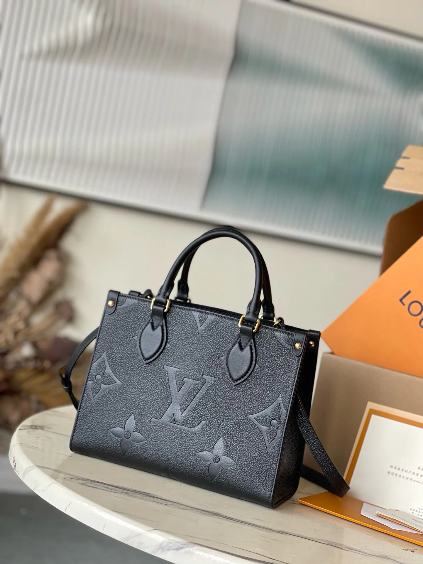 💰1040 (first-grain leather) top original M45653 black printed Onthego small Tote bag draws inspiration from the classic Sac Plat handbag in 1968. It is made of Monogram Empreinte leather with Medium Bicolor Monogram pattern embossed to create a miniature version, which can store daily needs such as iPad Mini. Flexible handles and detachable shoulder strap enrich carrying options. Dimensions: 25 x 19 x 11.5 cm