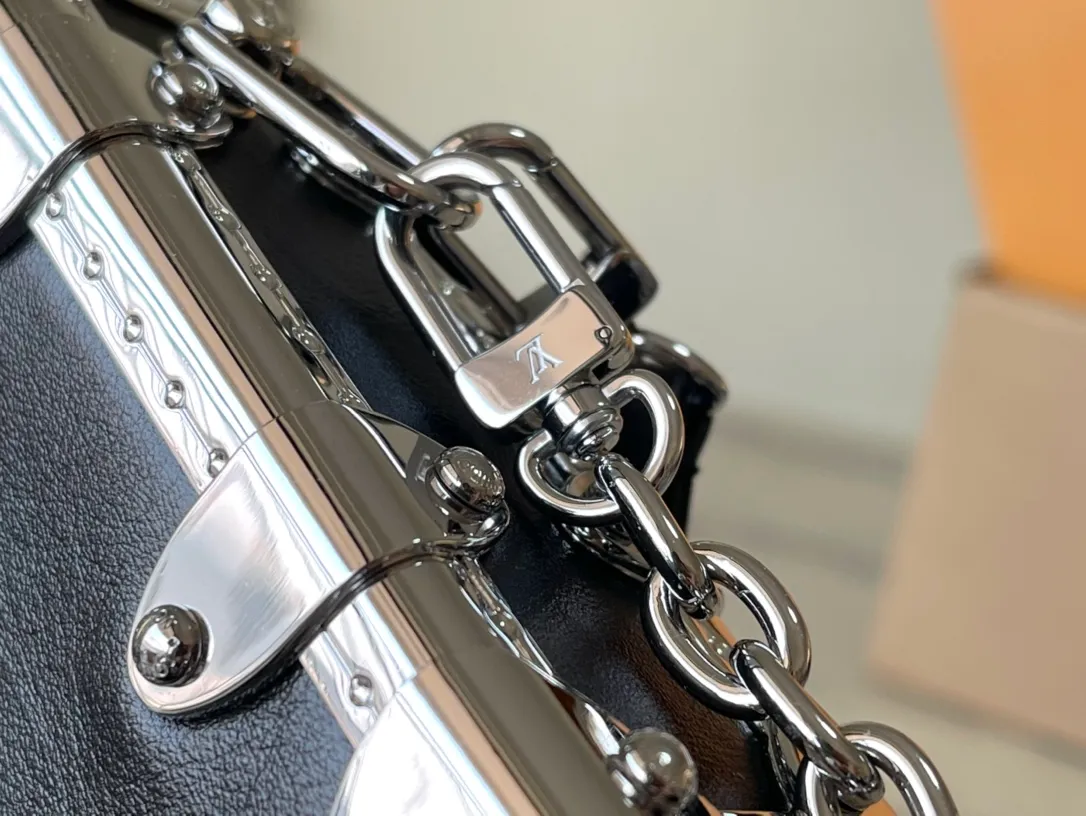 💰1420 (first-grain leather) Top-quality original order M25445 This Slim Trunk handbag draws inspiration from Louis Vuitton’s traditional hard trunk. The soft cow leather is integrated with rivet frames and metal S-lock locks, highlighting the avant-garde rock style. The shiny chain and adjustable leather shoulder strap are both detachable, providing a variety of carrying options. Dimensions: 23 × 12 × 4 cm