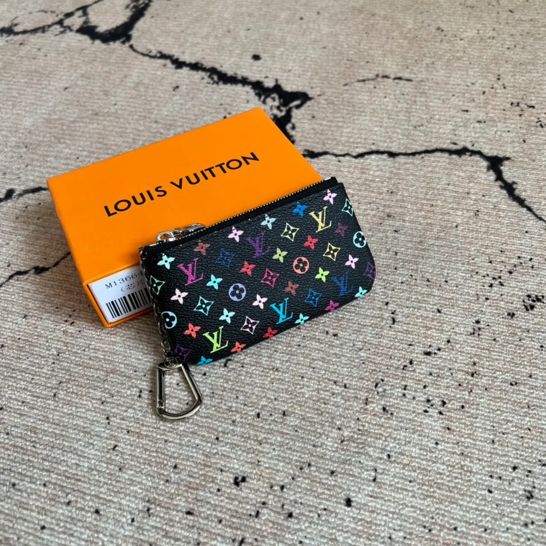 Factory price 280 Top original order M13664 black color This replica Louis Vuitton x Murakami series key coin purse is colorful and made of coated canvas. The vibrant iconic Monogram pattern reinterprets the brand logo with the theme of Japanese artist Takashi Murakami in rainbow tones. The key coin purse has a silver zipper and is equipped with a chain strap and hook buckle to store keys securely. 12 x 7 x 1.5 cm (length x height x width)