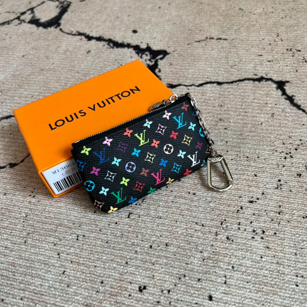 Factory price 280 Top original order M13664 black color This replica Louis Vuitton x Murakami series key coin purse is colorful and made of coated canvas. The vibrant iconic Monogram pattern reinterprets the brand logo with the theme of Japanese artist Takashi Murakami in rainbow tones. The key coin purse has a silver zipper and is equipped with a chain strap and hook buckle to store keys securely. 12 x 7 x 1.5 cm (length x height x width)