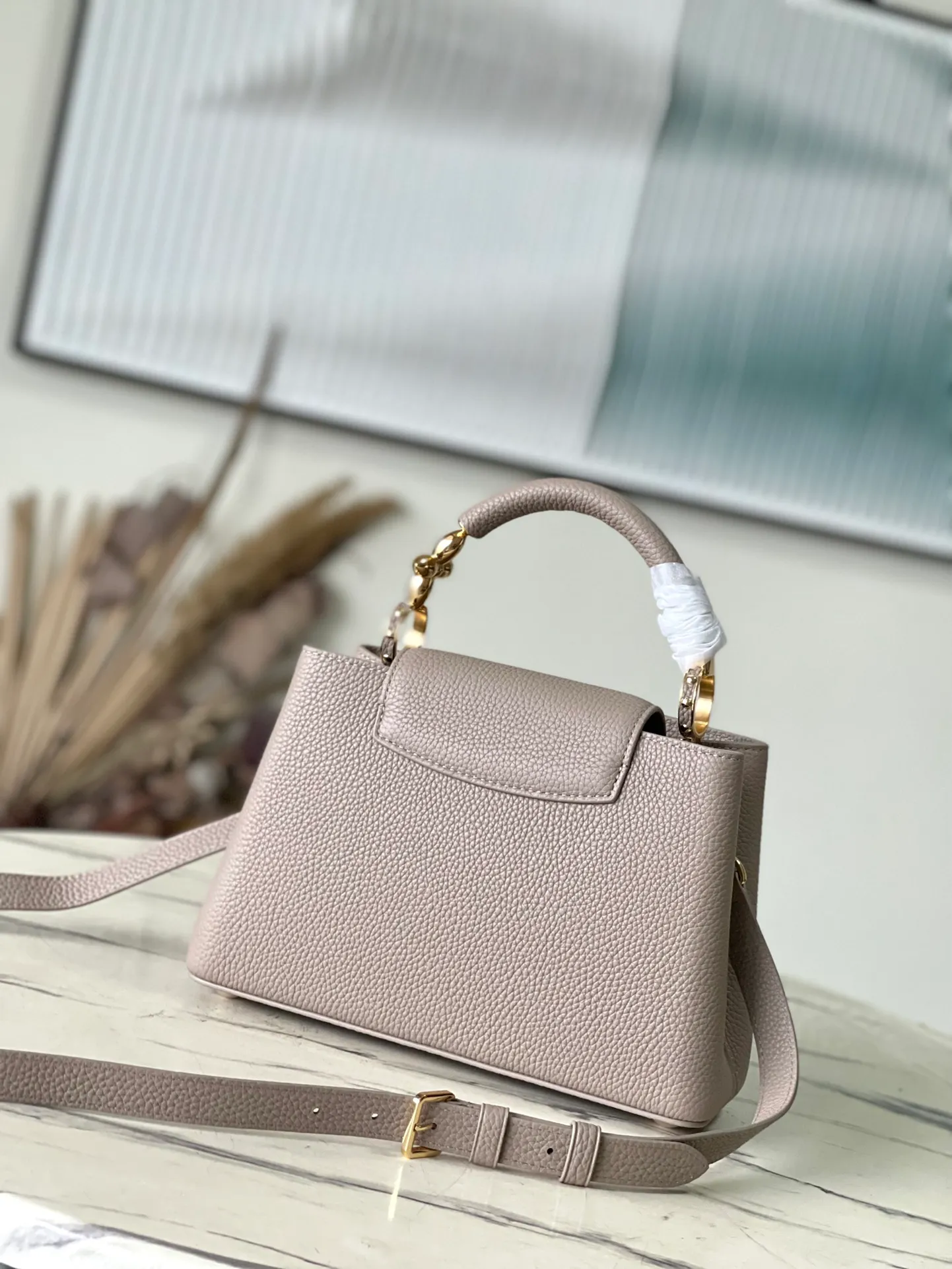 💰2360 (Special Grade Original Leather) M24698 Elephant Gray Small Size This Capucines BB handbag is made of Taurillon cow leather embellished with shiny metal parts, and the LV letters are written with 3D strokes. Metal Monogram flowers bloom quietly on the rolled leather handle, subtly proving the brand's exquisite craftsmanship. The detachable and adjustable leather shoulder strap allows for comfortable shoulder carrying. Dimensions: 26.5 × 17.5 × 9 cm