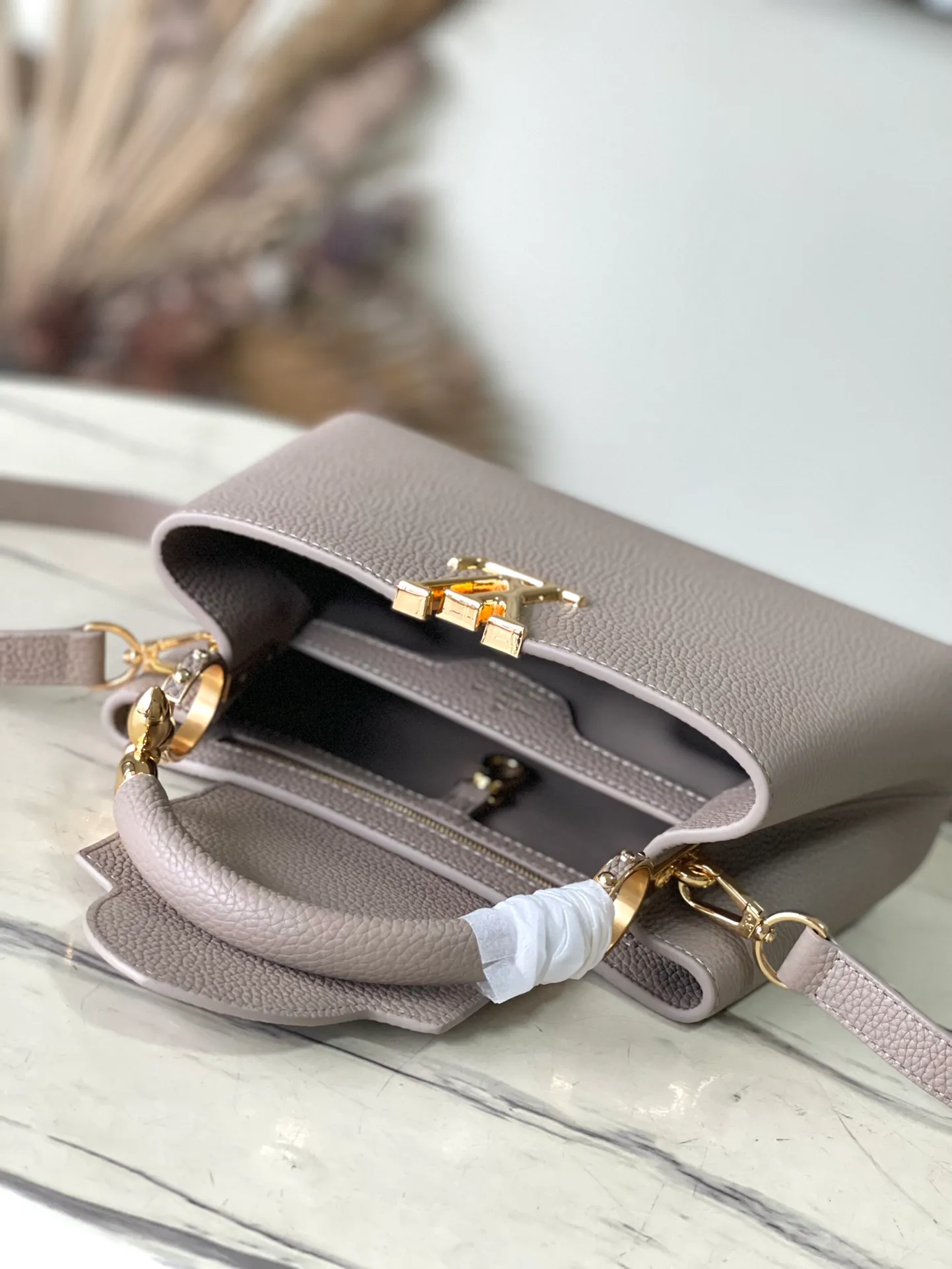 💰2360 (Special Grade Original Leather) M24698 Elephant Gray Small Size This Capucines BB handbag is made of Taurillon cow leather embellished with shiny metal parts, and the LV letters are written with 3D strokes. Metal Monogram flowers bloom quietly on the rolled leather handle, subtly proving the brand's exquisite craftsmanship. The detachable and adjustable leather shoulder strap allows for comfortable shoulder carrying. Dimensions: 26.5 × 17.5 × 9 cm