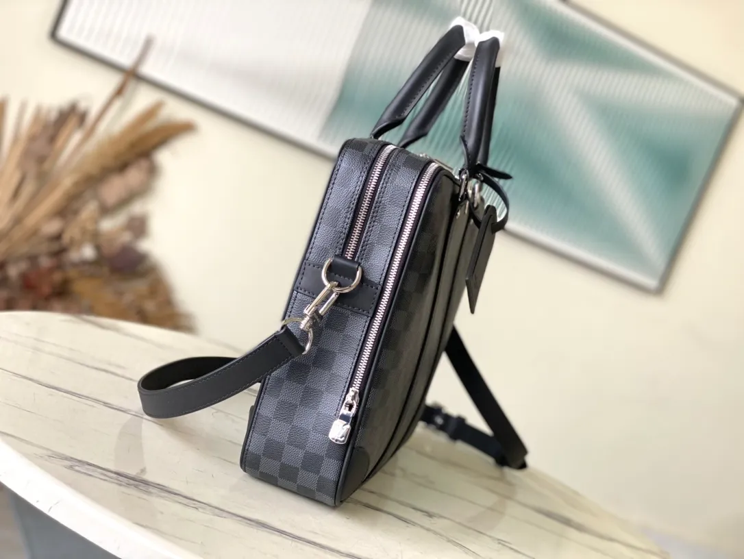 💰1100 Top original order N40485 Voyage large briefcase is a space upgrade on the classic Attache briefcase. Damier Graphite canvas body with cowhide leather trim, extra side straps and top handles. A padded interior compartment holds a laptop, and dual patch pockets and zip pockets add functionality. Dimensions: 39.5 × 29 × 9 cm