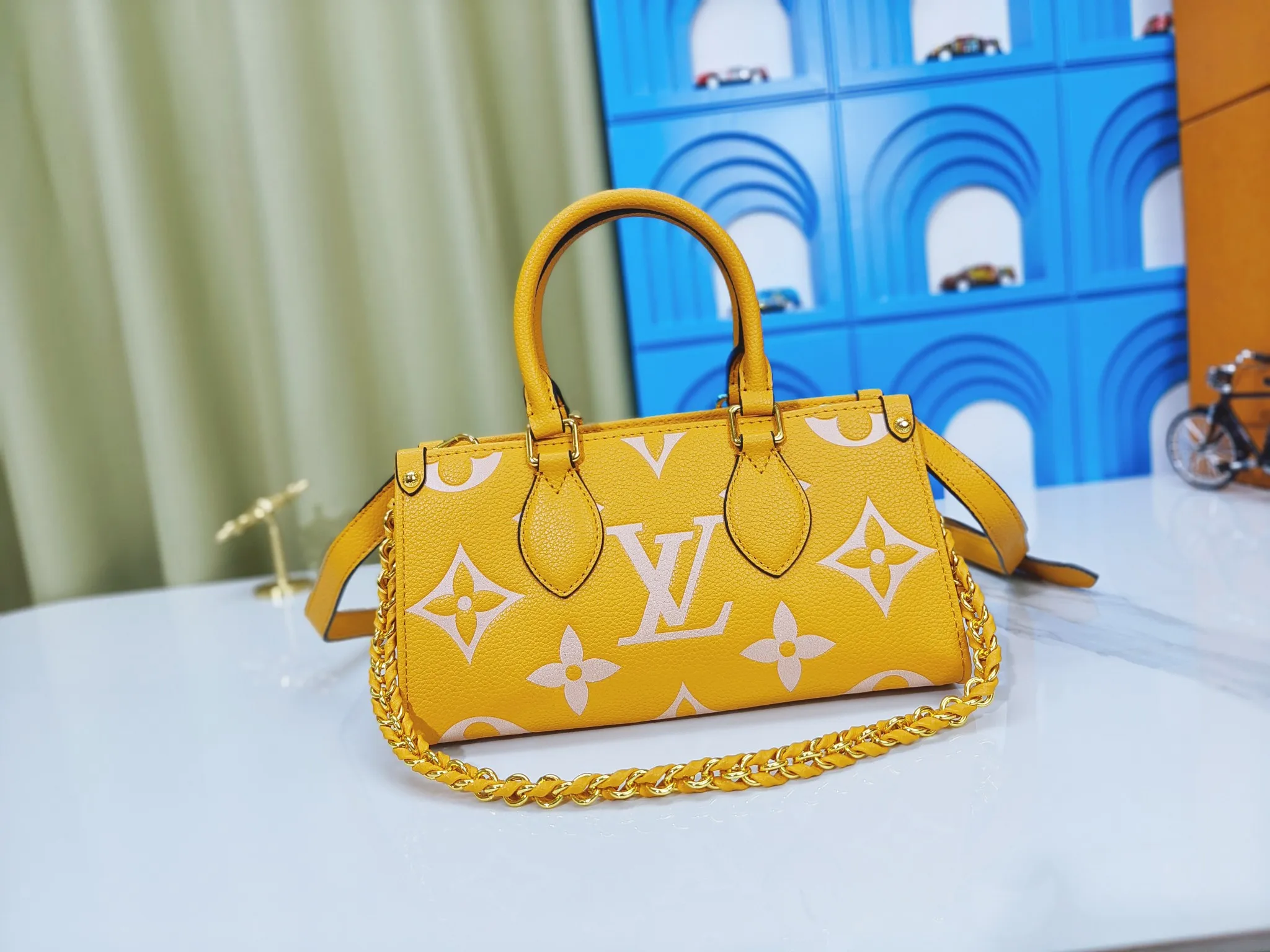 💰240💰Upgraded original M23640 M23698 M46653 This OnTheGo East West handbag introduces the OnTheGo small tote bag design, using Monogram Empreinte leather to reinterpret the ample configuration of East West. The Giant Monogram is embossed on the leather body, and the neat interior can store daily necessities. The top handle and removable leather chain strap allow for multiple carry options. 25 x 13 x 10 cm