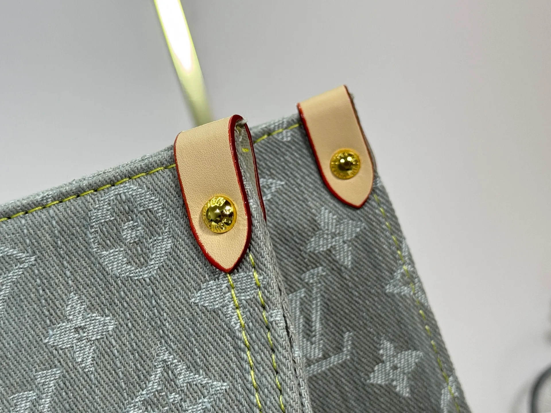 P320 M49495 M45659 M13189 New Gray Denim Denim This edition of OnTheGo MM celebrates the return of the iconic Monogram denim pattern in 2005. It's made from organic cotton, artfully woven with black and white threads and then bleached using a special Louis Vuitton technique to create a vintage-inspired finish. It's sized to hold a laptop, features light gold hardware, and includes signature details like natural leather accents and a removable name tag. Dimensions: 35 x 27 x 14 cm