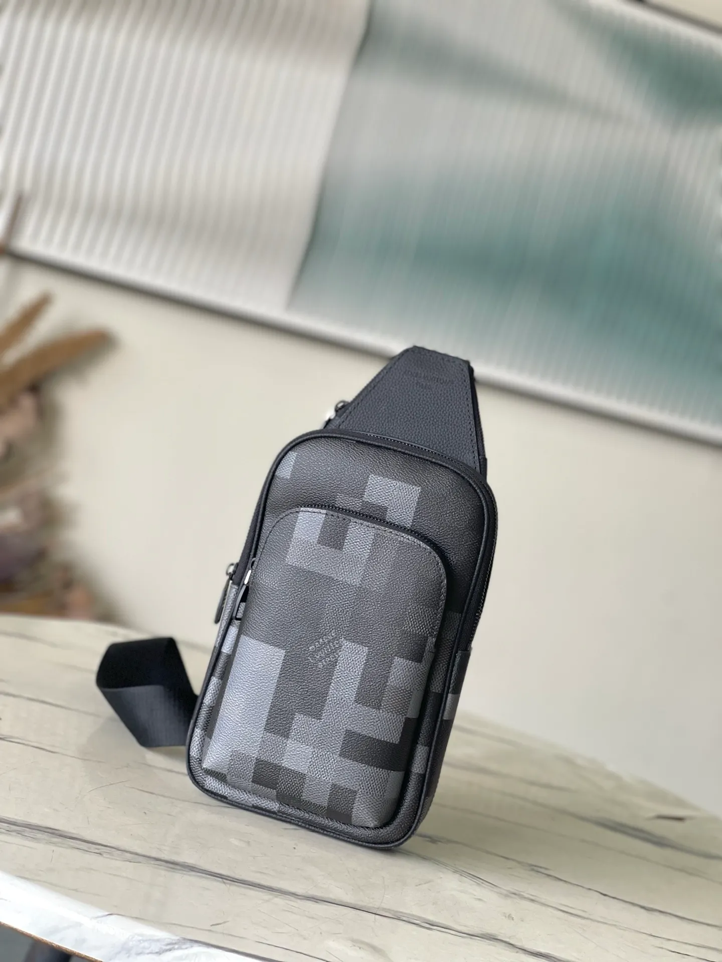 💰900 Top Original M14953 Damoflage black coated canvas adds a contemporary feel to the Avenue Slingbag's modern silhouette. A pixelated checkerboard pattern of grays and blacks is paired with matte black hardware for a masculine look. The Avenue features a main compartment and two zippered pockets for added functionality. The single shoulder strap is adjustable for comfortable cross-body wear. Appearance may vary slightly depending on pattern placement. Size: 16*5.7*33cm
