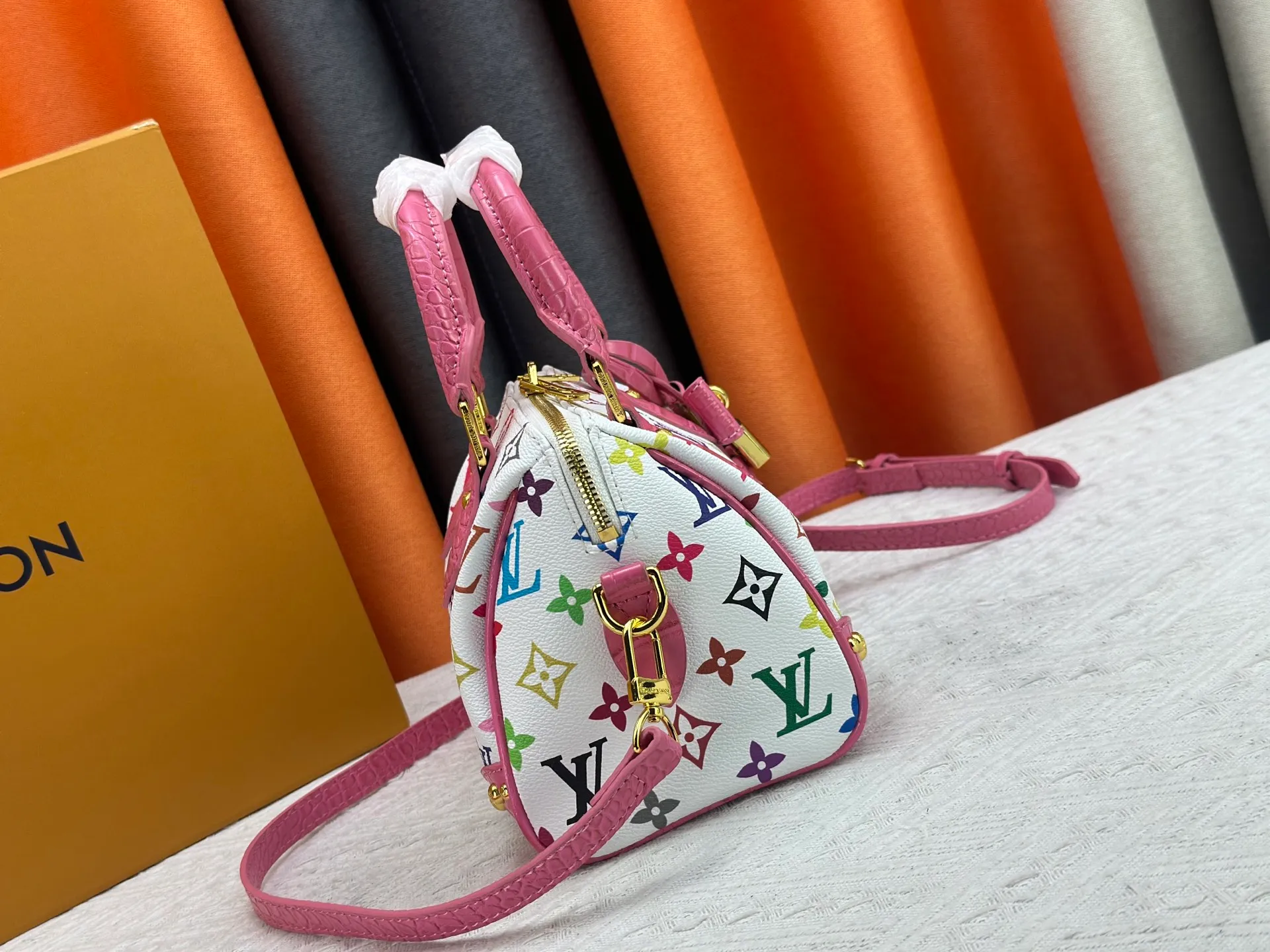 P260 Upgraded original crocodile pattern M13365 M58953 M46234 M46222 Speedy Bandoulière 20 handbag is made of soft coated canvas, and the full-length Monogram pattern is traced in colorful rainbow tones, highlighting the smart style of the Louis Vuitton x Murakami reissue series. The Toron handle and detachable shoulder strap are constructed of cow leather, the metal corners recall classic luggage elements, and the bow-shaped key bag and padlock add brand touches. Dimensions: 20.5 x 13.5 x 12.0 cm (length x height x width)