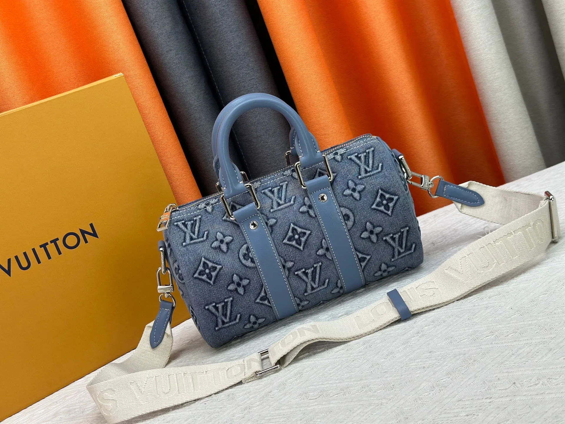 P260 Upgraded original M22762 This Keepall Bandoulière 25 handbag displays the vintage texture of Monogram Washed Demin canvas. The Monogram pattern is outlined with embossing and hand-painting techniques, as if it were a faded denim that has been baptized by time. It is paired with a retro-style nameplate and a detachable and adjustable shoulder strap. 25.0 x 15.0 x 11.0 cm (length x height x width)