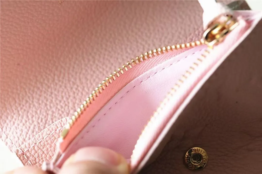 Factory price 280 [Top original order] M81455 pink first-layer cowhide👏👏This Rosalie coin purse is made of Monogram Empreinte embossed soft-grained cowhide. It opens with a round flip cover and has a compact configuration. It has a zippered coin pocket, a patch pocket and a card compartment inside. Louis Vuitton logo-engraved snaps secure the closure. Size: 11X8X2.5cm.