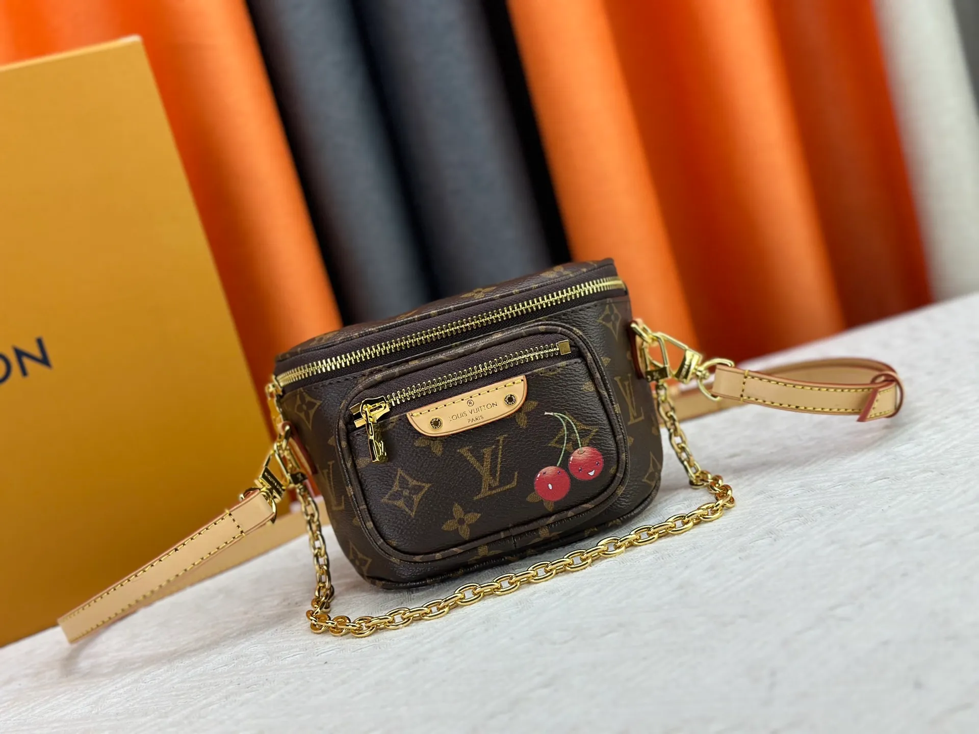 P240 M82208 M00130 M82335 This Mini Bumbag handbag comes from the LV Gradient series. The Monogram embossing of Monogram Empreinte leather renders the gradient midsummer color. The on-trend construction features a zipped main compartment and a front pocket with a Louis Vuitton leather label. With the detachable chain and detachable and adjustable shoulder strap, it can be worn as a shoulder or cross-body bag. Dimensions: 17x12x9.5 cm