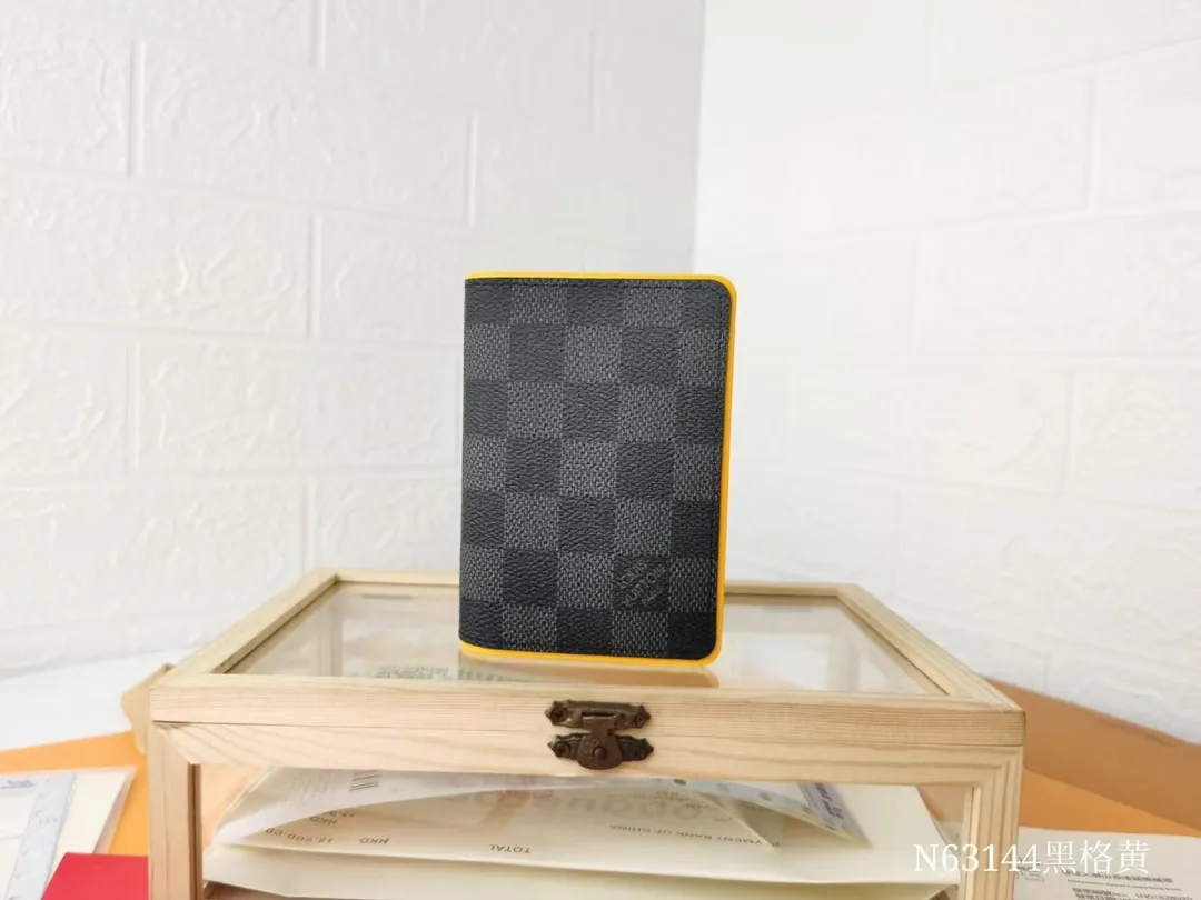 P110💰Top Original💎N63144 black check with yellow, this pocket wallet combines the elegance of Damier Graphite canvas with the delicate texture of Epi leather, with stripes emblazoned with the Louis Vuitton logo. The elegant design can accommodate credit cards, banknotes and receipts, making it suitable for daily carrying or gift giving. Detailed Features 8.0 x 11.0 x 1.0 cm (L x H x W) Epi leather and Damier Graphite coated canvas Coated cowhide leather trim Cowhide lining, card compartment, inner pocket, outer patch pocket This product is made in one of France, Spain, Italy and the United States