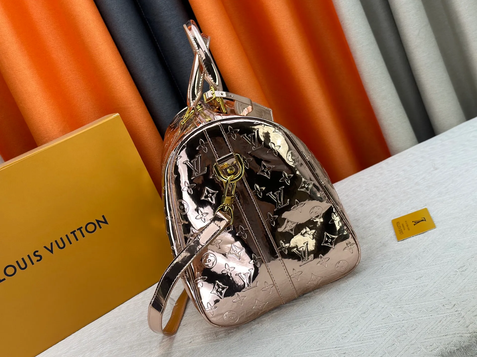 P360 M26463 M41418 Rose Gold This Speedy Bandoulière 45 handbag is from the LV Ski series. It is made of embossed coated canvas decorated with smooth leather trim and bright metal parts, and then uses the new Monogram Miroir effect to declare the retro-futuristic concept. The detachable and adjustable leather shoulder strap allows for a variety of carrying options, and the compact design can accommodate daily needs such as a long wallet. Dimensions: 45x27x20