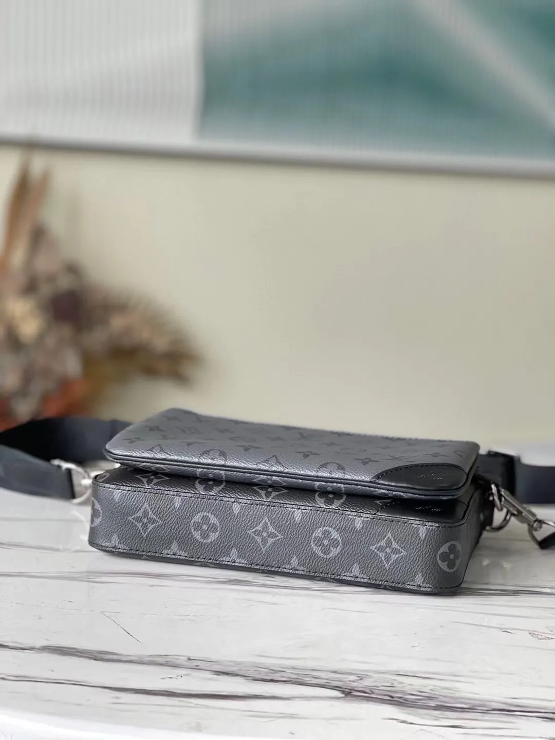 💰720 Top original M69443 Trio messenger bag is made of Monogram Eclipse canvas and Monogram Eclipse Reverse canvas. A signature tonal gray pattern accentuates the lines of this versatile, modular design. In addition to the functions of a traditional cross-body bag, it also comes with a removable zipper bag and a coin purse attached to the strap. Dimensions: 25 x 18.5 x 7 cm