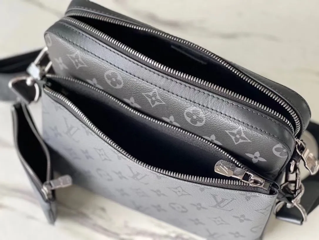 💰720 Top original M69443 Trio messenger bag is made of Monogram Eclipse canvas and Monogram Eclipse Reverse canvas. A signature tonal gray pattern accentuates the lines of this versatile, modular design. In addition to the functions of a traditional cross-body bag, it also comes with a removable zipper bag and a coin purse attached to the strap. Dimensions: 25 x 18.5 x 7 cm