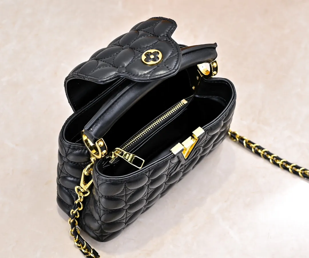 Upgraded version P420 M23998 Black This Monogram embroidered flower emerges from the elegant quilting, bringing the style of Louis Vuitton store decoration to the Capucines mini handbag. Soft sheepskin creates a stable structure and trim, and the detachable shoulder strap allows for comfortable shoulder or cross-body wear. Dimensions: 22 x 12 x 8 cm