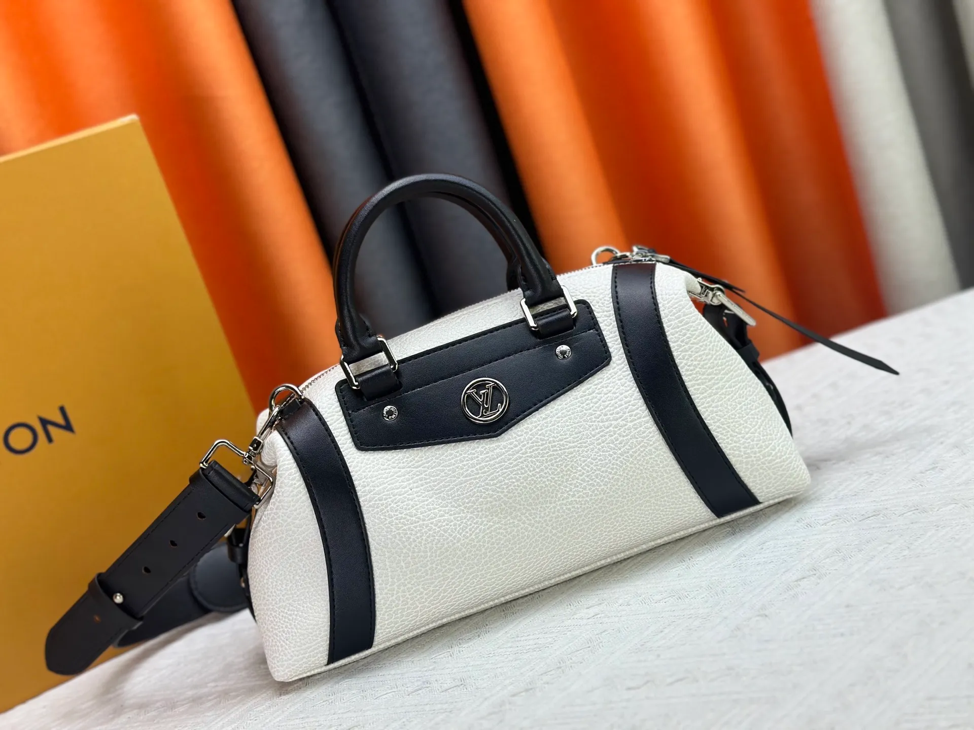 P300 small P320 medium P340 large M25557 M25561 M25561 M25566 Black M14623 mini M14514 small M14700 medium Dark gray M14702 medium Light gray M14721 small This Nano LV Rider handbag is from 2025 For the spring and summer series, pixelated grained sheep leather is blended with smooth cow leather elements, and the LV Circle logo is highlighted with elegant patches. The foldable configuration makes it easy to store in a suitcase, and the modern design adds a rock-n-roll edge to any look.  Mini 10 x 10 x 23 cm Small 12 × 12 × 30 cm Medium 15 × 15 × 38 cm (H x W x L) Sheep leather Cow leather trim Textile lining Metal hardware Zipper closure Side slip straps Internal pocket Holds a 6.7-inch smartphone, Romy card holder and lipstick Shoulder strap: removable, adjustable Strap half-length: 30.0 cm Bag strap half length adjustable to: 45.0 cm Handle: double handle