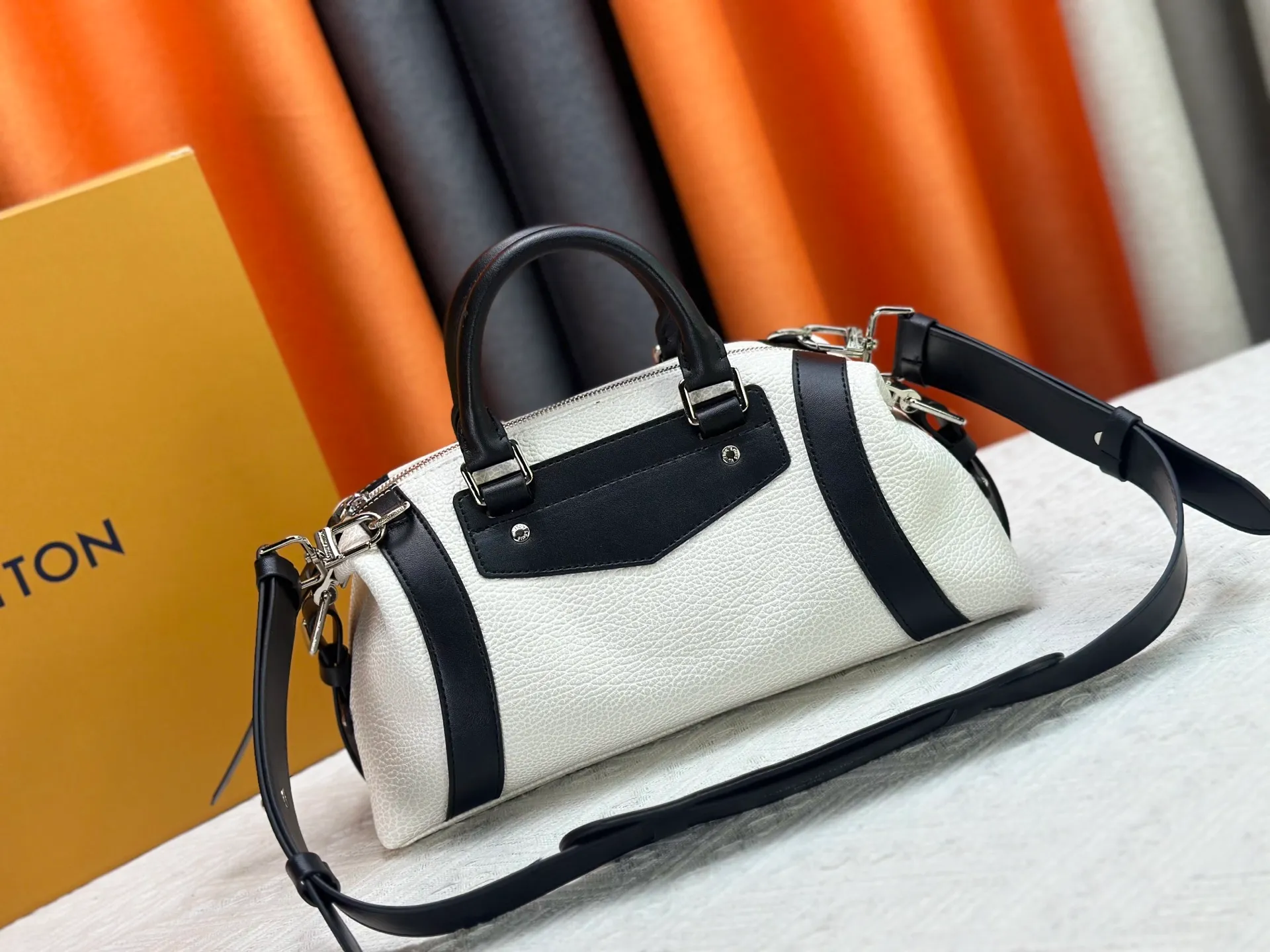 P300 small P320 medium P340 large M25557 M25561 M25561 M25566 Black M14623 mini M14514 small M14700 medium Dark gray M14702 medium Light gray M14721 small This Nano LV Rider handbag is from 2025 For the spring and summer series, pixelated grained sheep leather is blended with smooth cow leather elements, and the LV Circle logo is highlighted with elegant patches. The foldable configuration makes it easy to store in a suitcase, and the modern design adds a rock-n-roll edge to any look.  Mini 10 x 10 x 23 cm Small 12 × 12 × 30 cm Medium 15 × 15 × 38 cm (H x W x L) Sheep leather Cow leather trim Textile lining Metal hardware Zipper closure Side slip straps Internal pocket Holds a 6.7-inch smartphone, Romy card holder and lipstick Shoulder strap: removable, adjustable Strap half-length: 30.0 cm Bag strap half length adjustable to: 45.0 cm Handle: double handle
