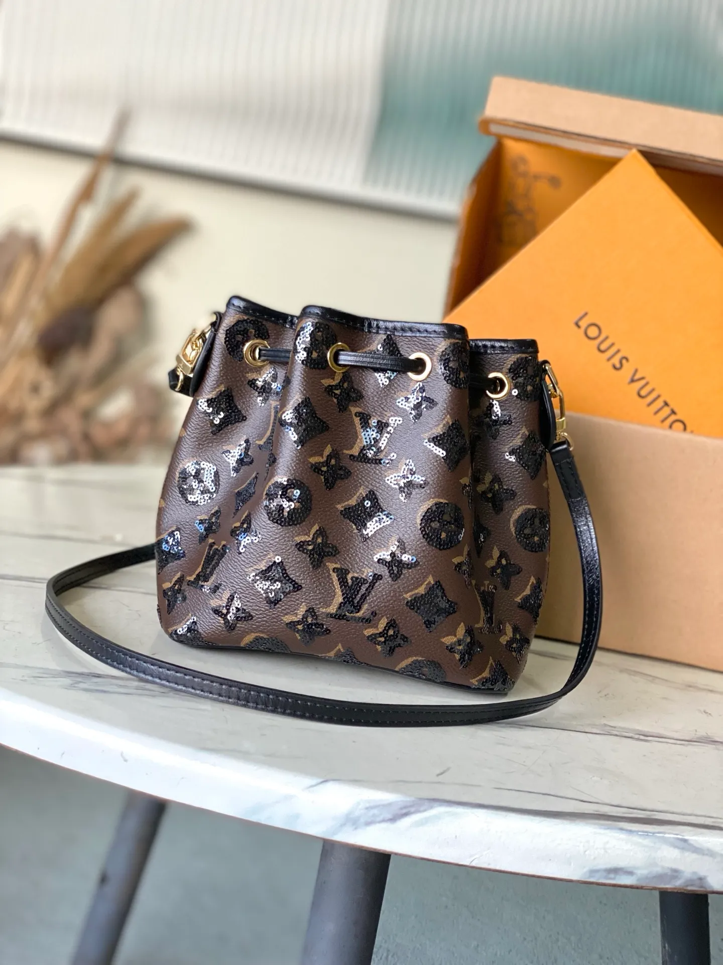 💰1180 Top original order M26284 This NoeBB handbag is from the LVSki series. The canvas body is decorated with bright Monogram pattern sequins. The glossy appearance is suitable for attending night occasions in the countryside and the city. The dazzling thick chain reinterprets the original 1932 configuration, and is just the right size to store your favorite lipstick and other personal items. Dimensions: 22 × 17.5 × 13 cm