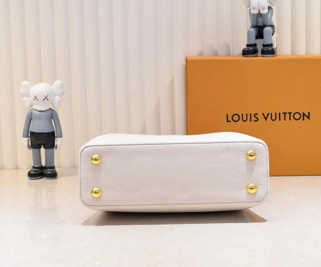 The upgraded version of the P460 M24698 Capucines BB handbag is made of Taurillon cow leather decorated with shiny metal parts, and the LV letters are written in 3D strokes. Metal Monogram flowers bloom quietly on the rolled leather handle, subtly proving the brand's exquisite craftsmanship. The detachable and adjustable leather shoulder strap allows for comfortable shoulder carrying. Detailed features 26.5 x17.5 x9 cm